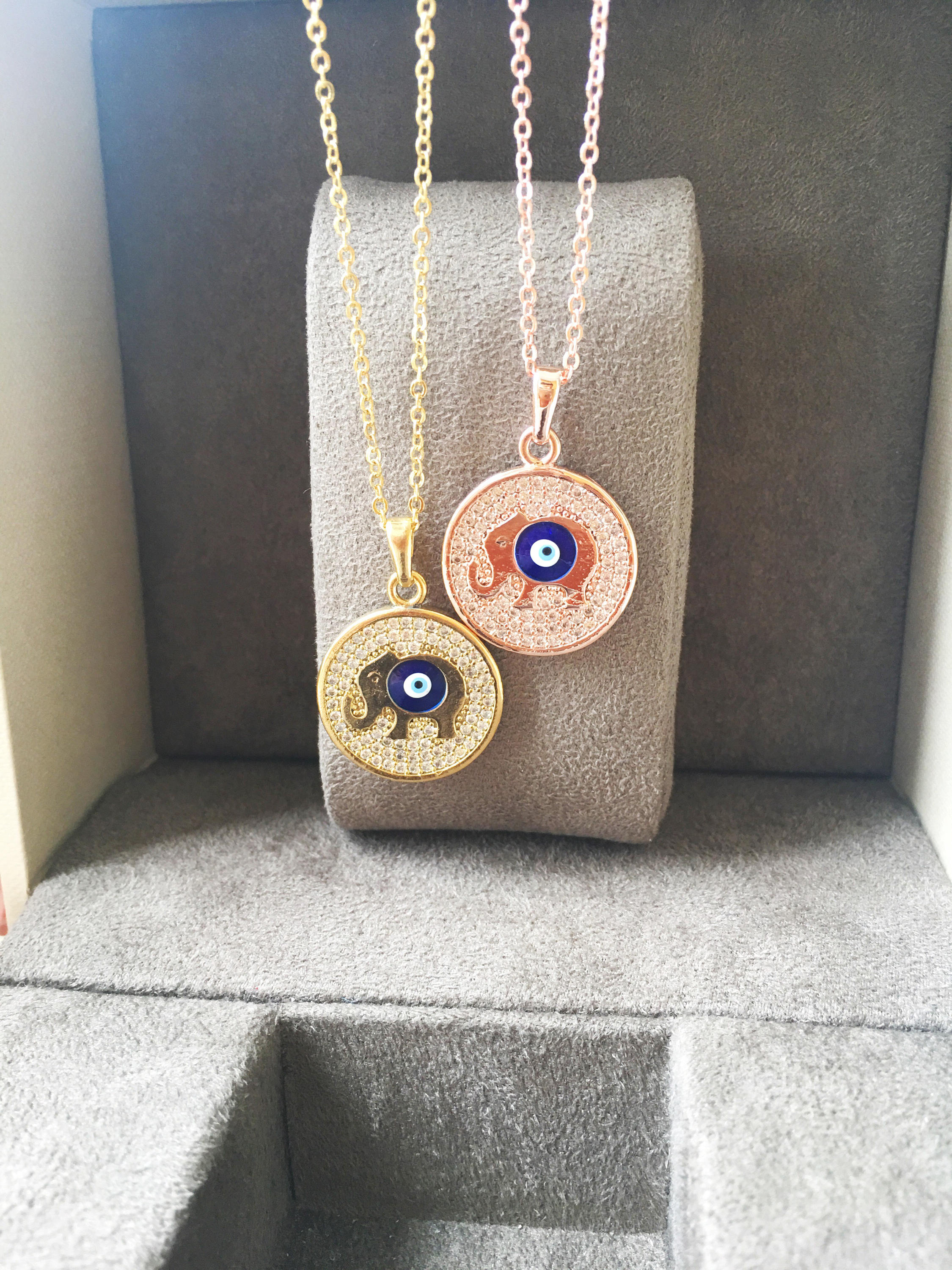 Zircon Evil Eye Necklace featuring an elephant charm on a rose gold chain, symbolizing protection and good luck.