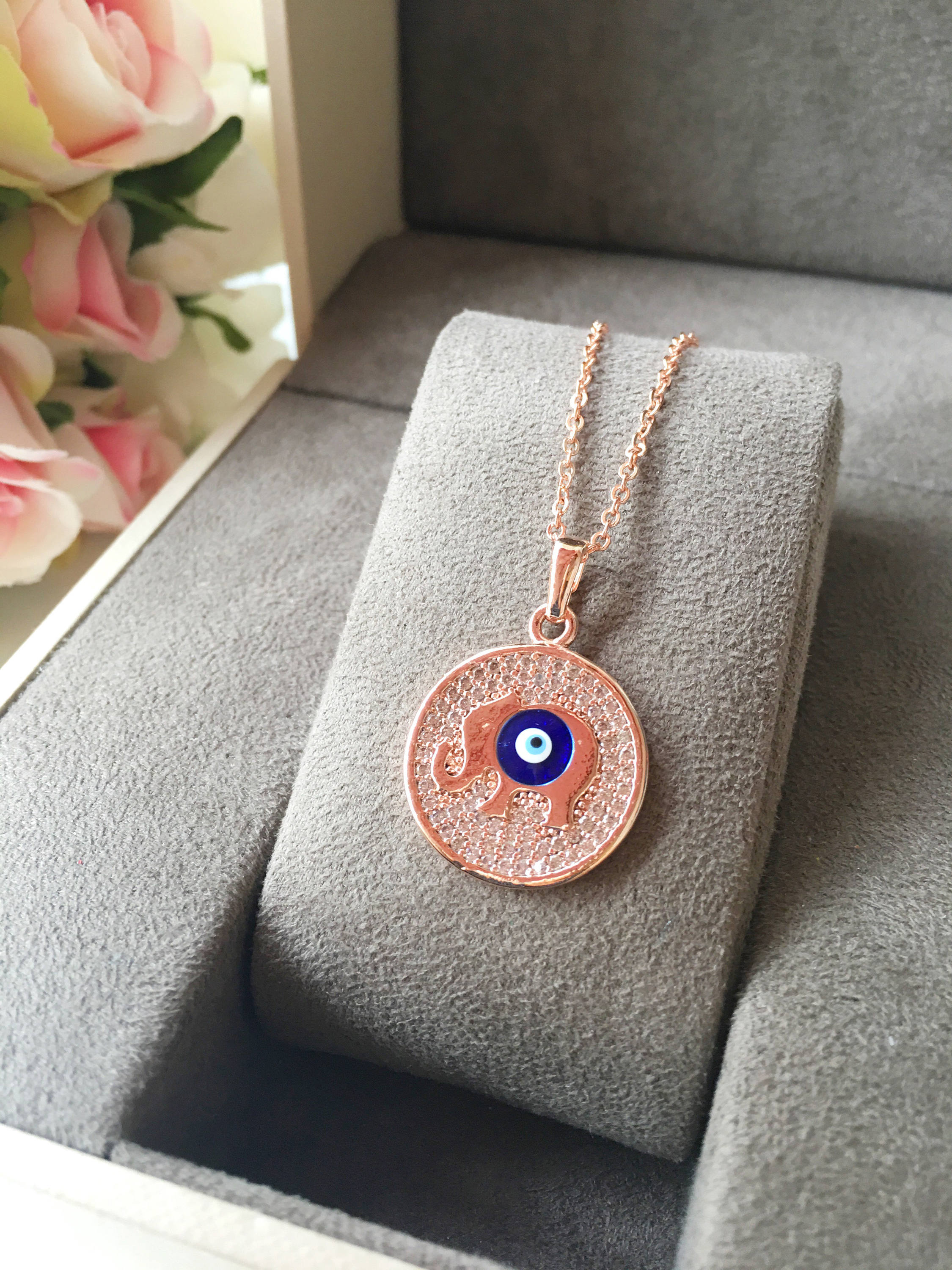 Zircon Evil Eye Necklace featuring an elephant charm on a rose gold chain, symbolizing protection and good luck.