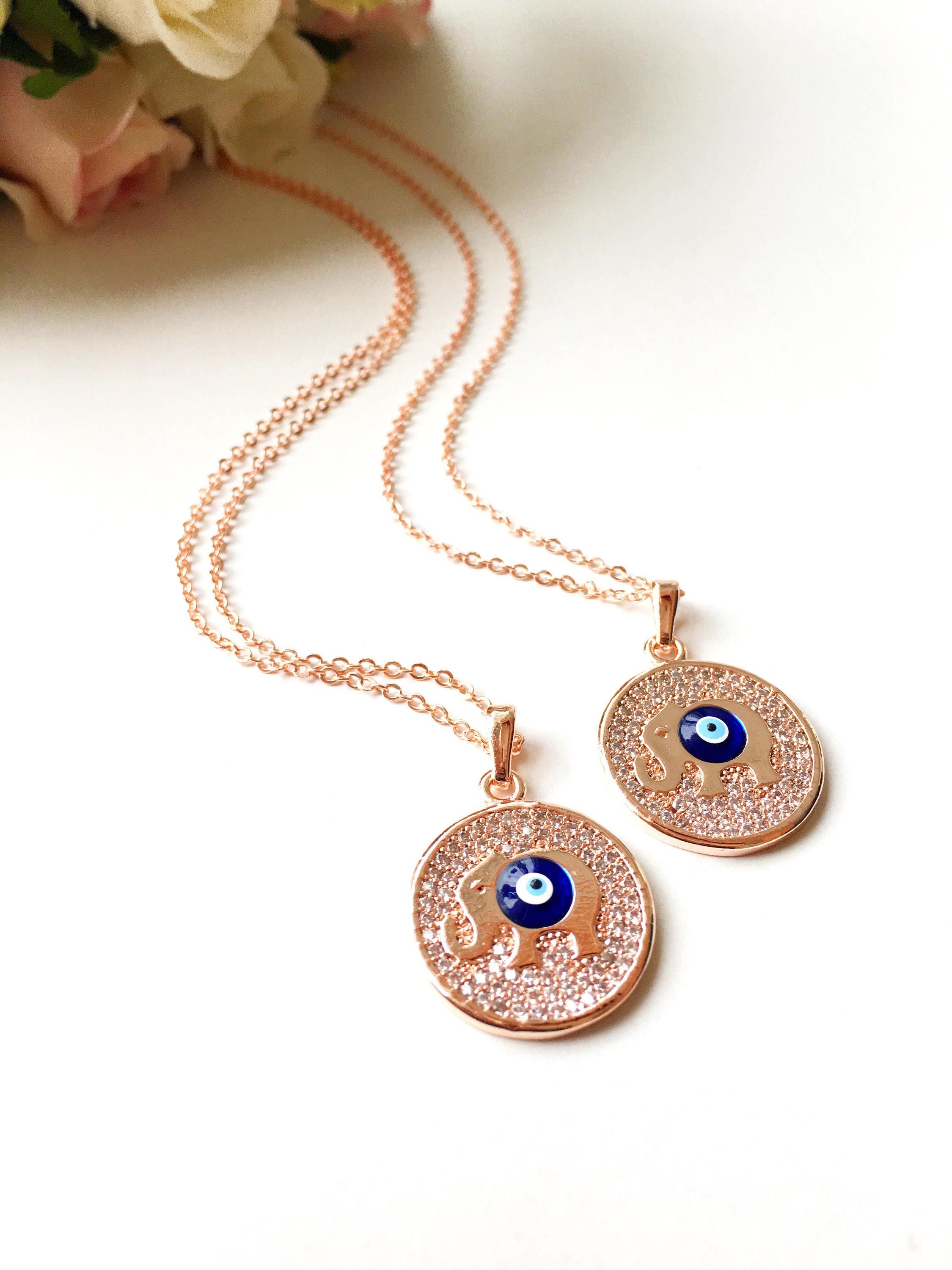 Zircon Evil Eye Necklace featuring an elephant charm on a rose gold chain, symbolizing protection and good luck.