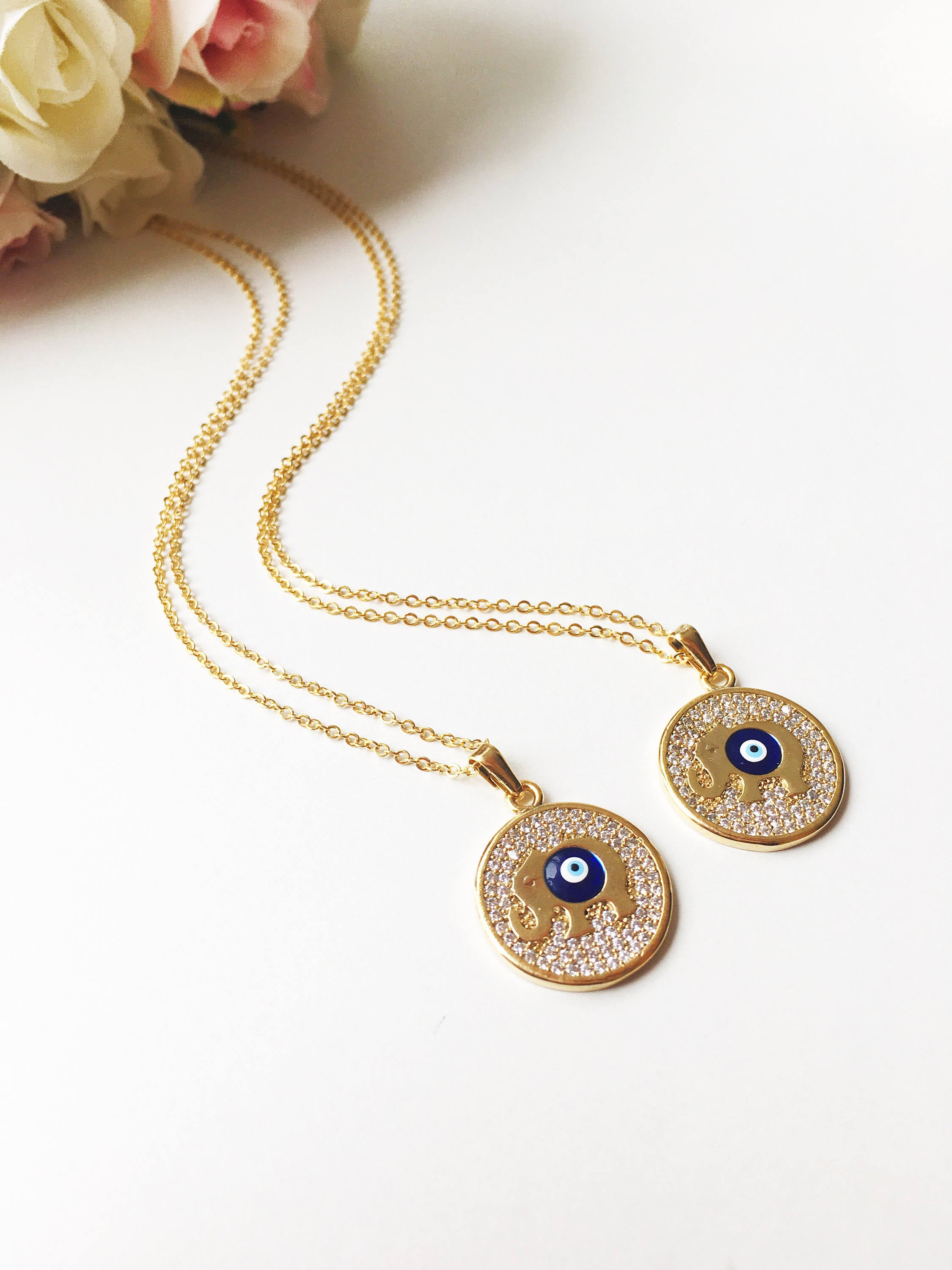 Zircon Evil Eye Necklace featuring an elephant charm on a rose gold chain, symbolizing protection and good luck.