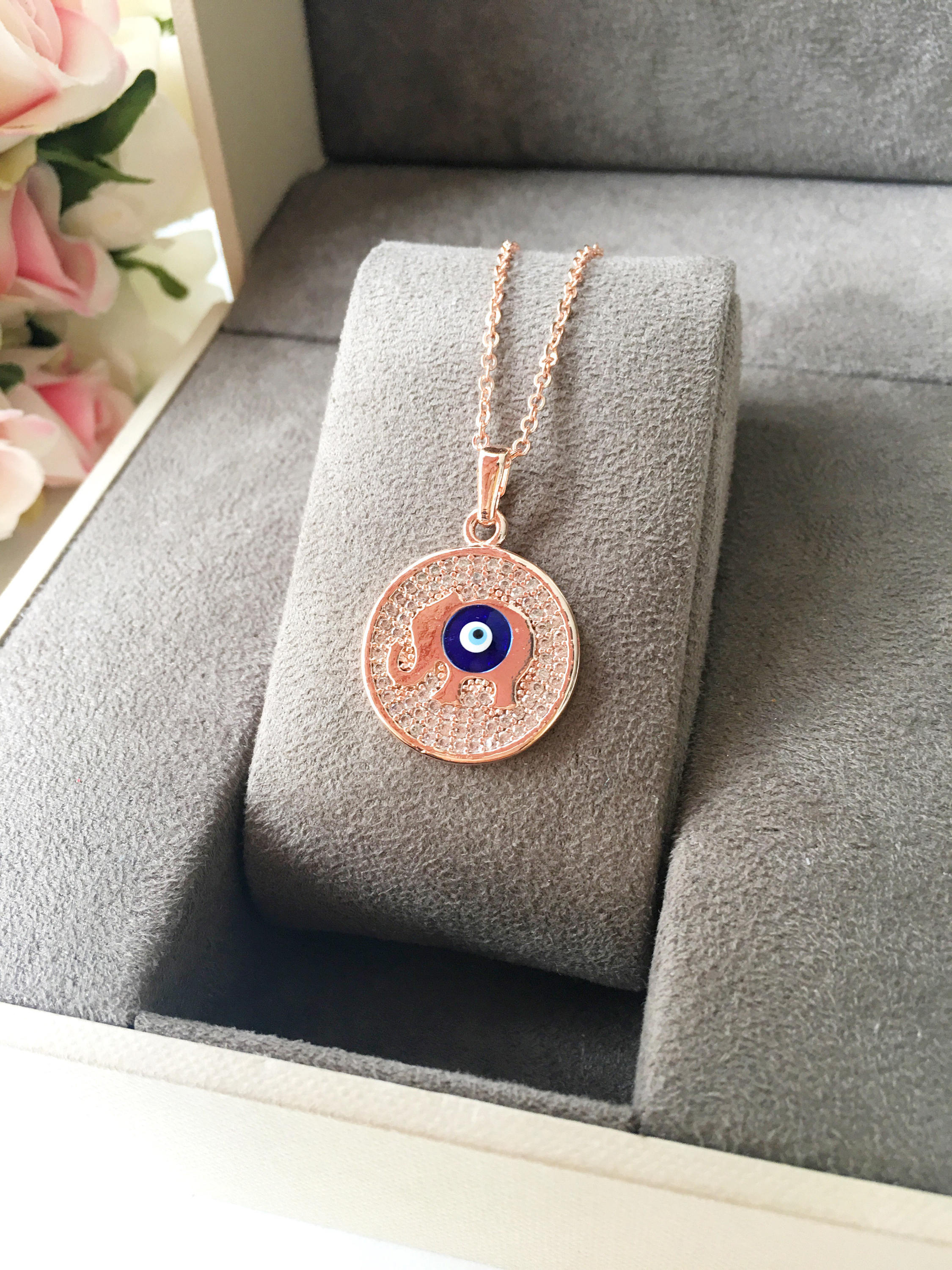 Zircon Evil Eye Necklace featuring an elephant charm on a rose gold chain, symbolizing protection and good luck.