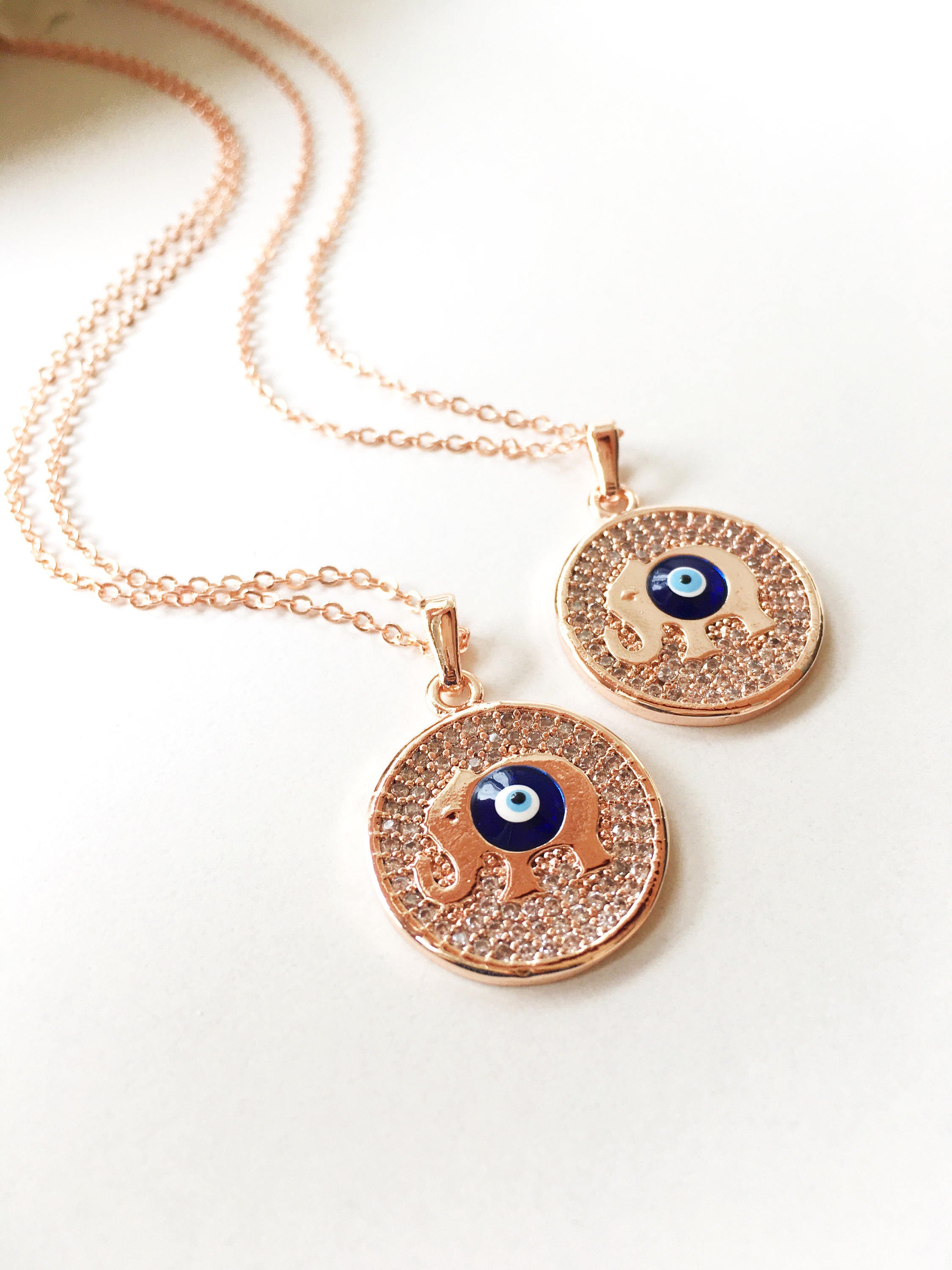 Zircon Evil Eye Necklace featuring an elephant charm on a rose gold chain, symbolizing protection and good luck.