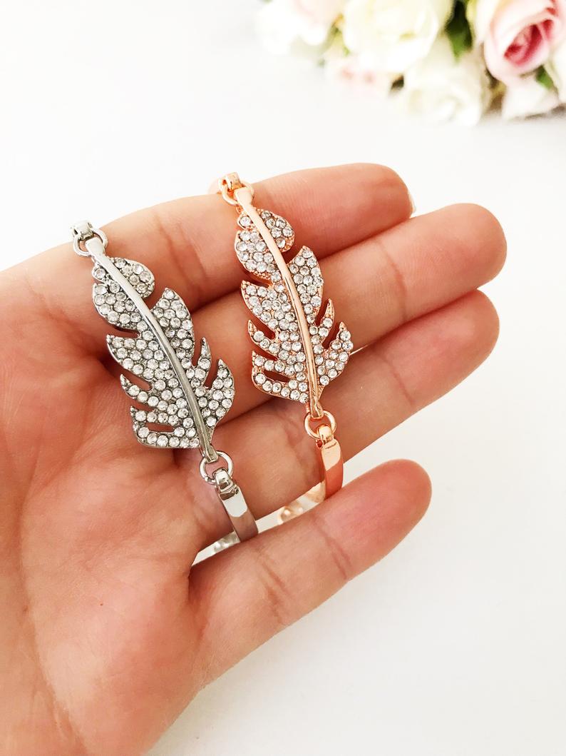 Zircon Leaf Charm Bracelet featuring a delicate leaf design in rose gold and silver, adorned with sparkling zirconia stones.