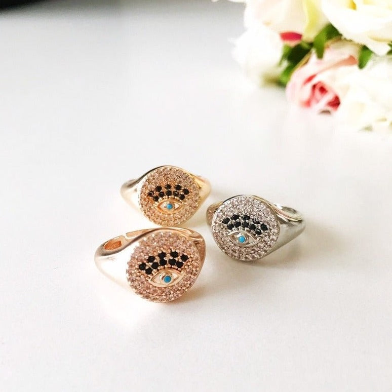 A beautiful adjustable Zirconia Evil Eye Ring featuring sparkling zirconia beads in a gold and silver finish, symbolizing protection and elegance.