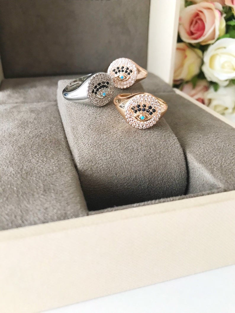 A beautiful adjustable Zirconia Evil Eye Ring featuring sparkling zirconia beads in a gold and silver finish, symbolizing protection and elegance.