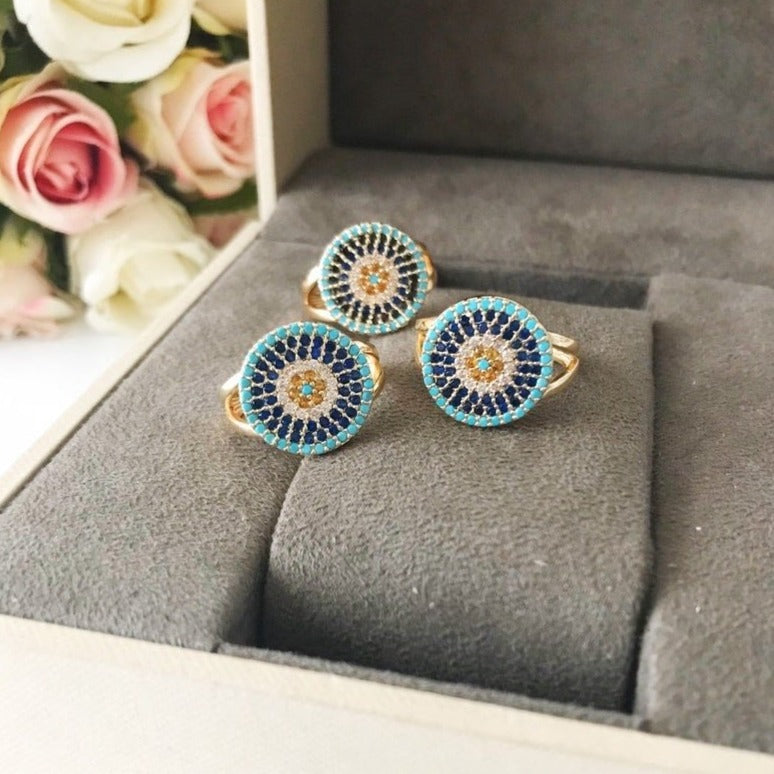 A beautiful adjustable Zirconia Evil Eye Ring featuring a blue evil eye design, adorned with sparkling zirconia beads, perfect for protection and style.