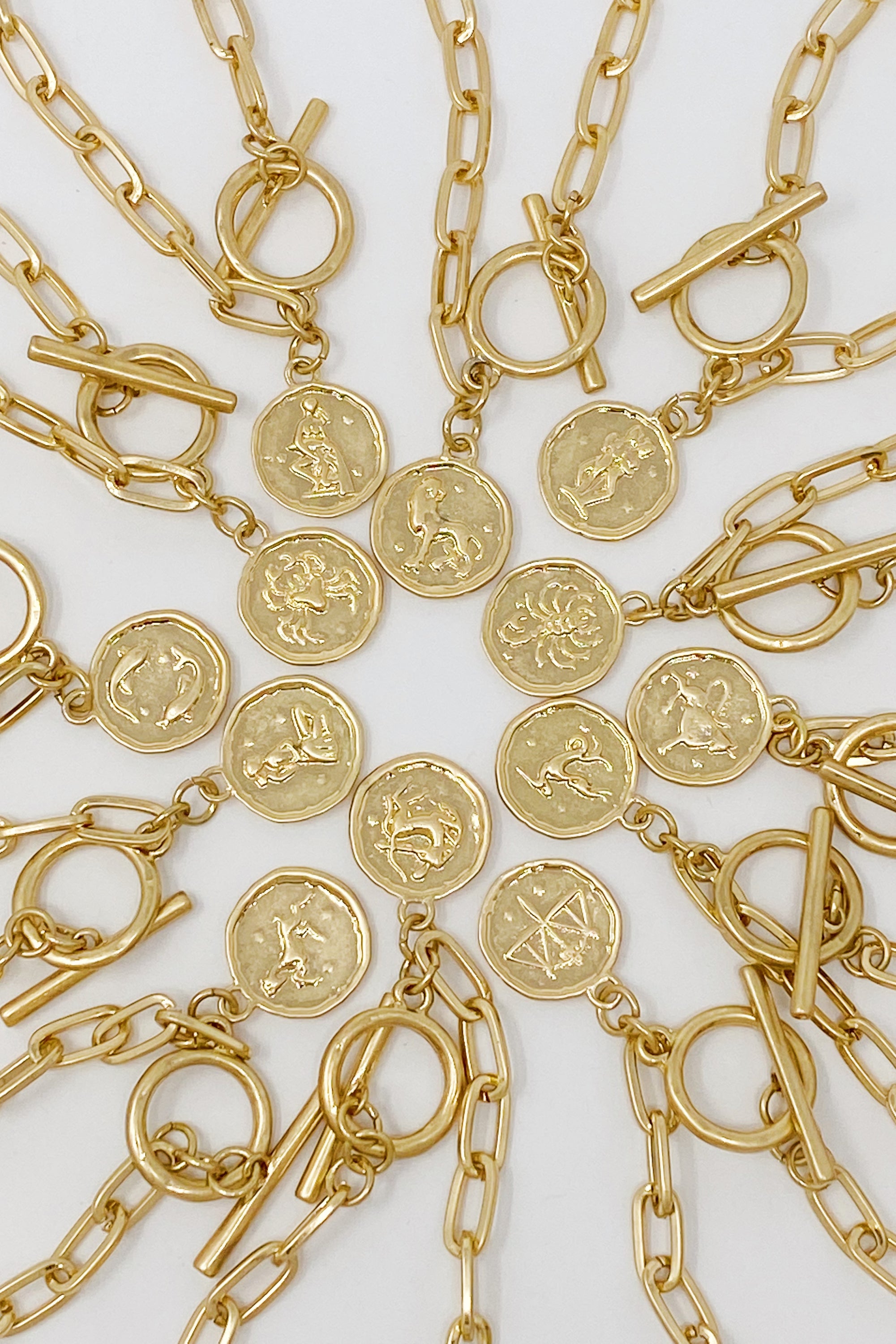 Zodiac Charm Chain Bracelet featuring a gold dipped brass link chain and a zodiac sign charm.