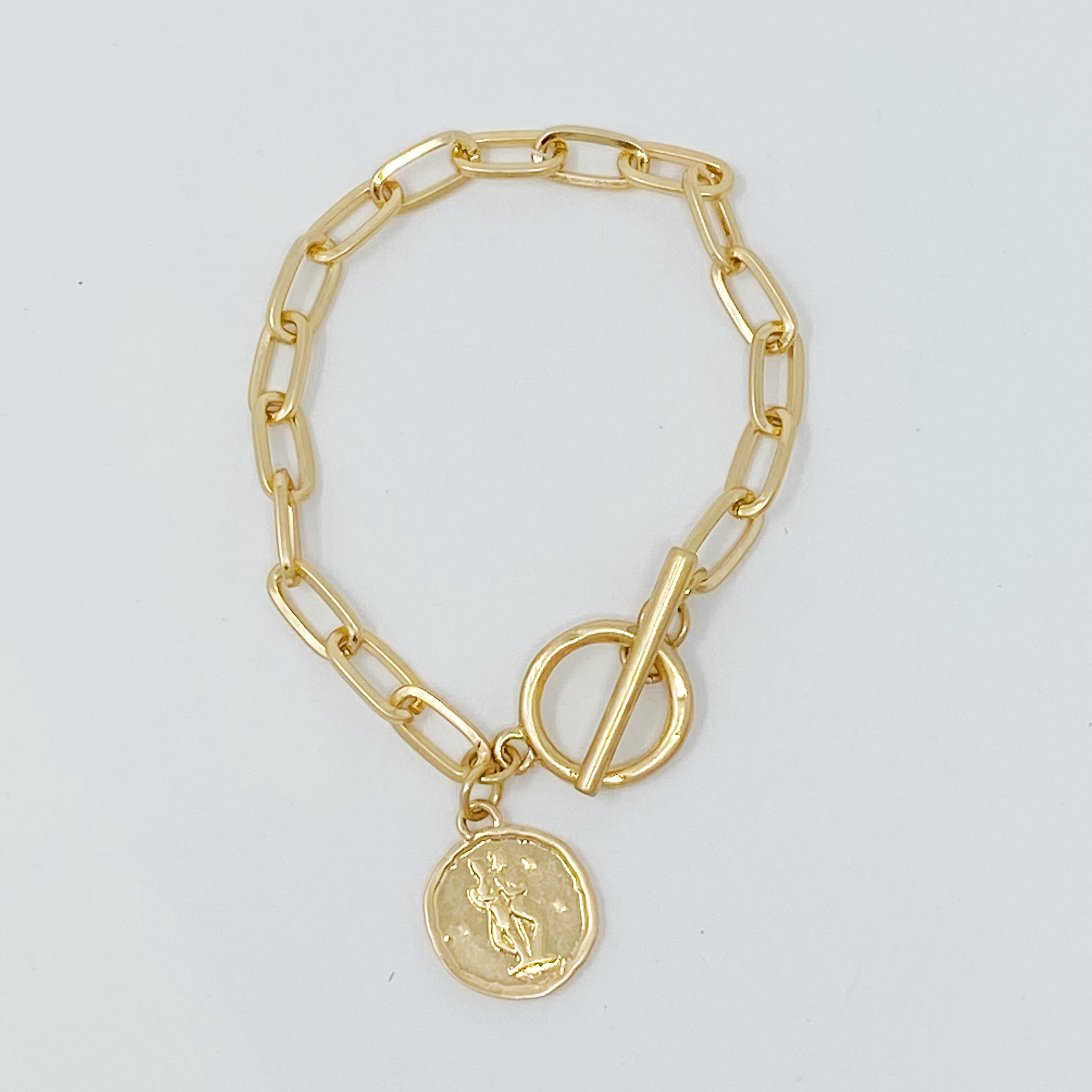 Zodiac Charm Chain Bracelet featuring a gold dipped brass link chain and a zodiac sign charm.