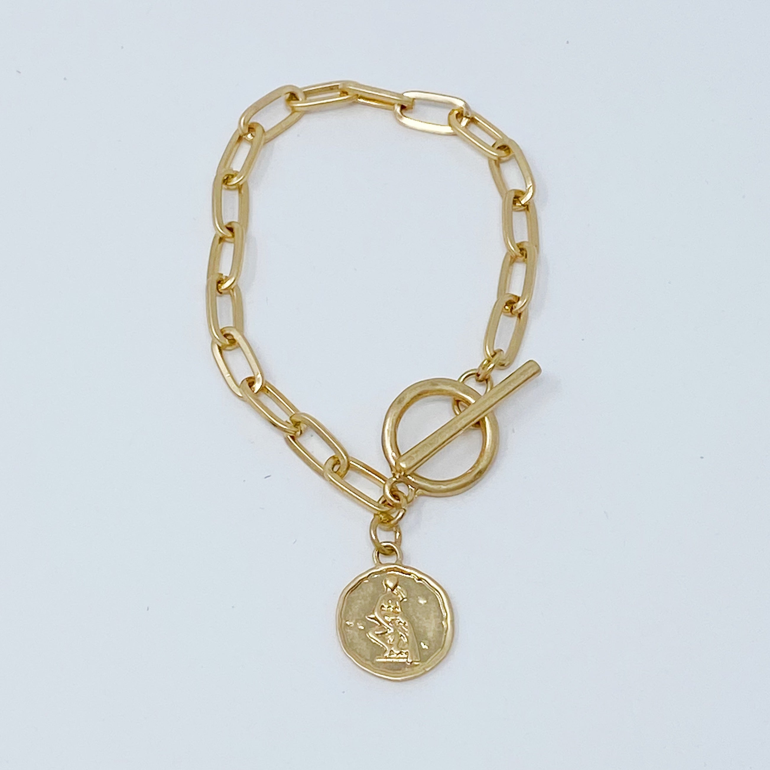 Zodiac Charm Chain Bracelet featuring a gold dipped brass link chain and a zodiac sign charm.