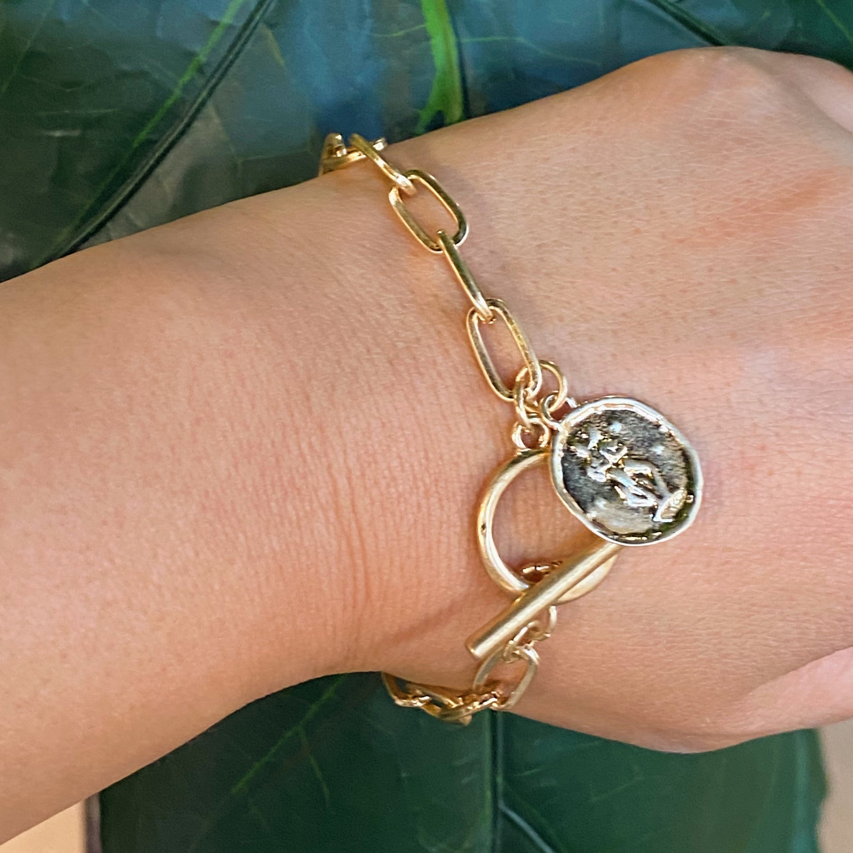 Zodiac Charm Chain Bracelet featuring a gold dipped brass link chain and a zodiac sign charm.