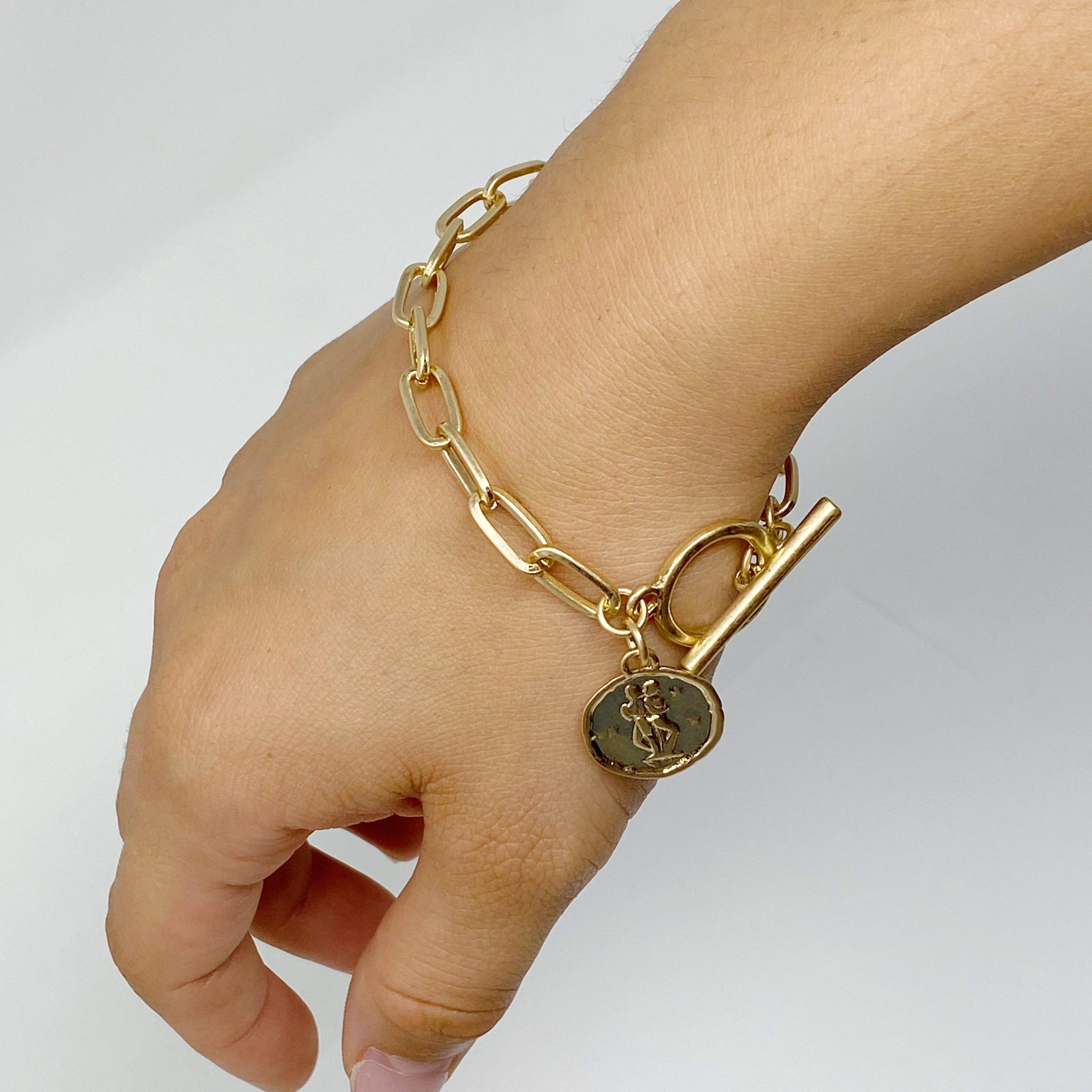 Zodiac Charm Chain Bracelet featuring a gold dipped brass link chain and a zodiac sign charm.