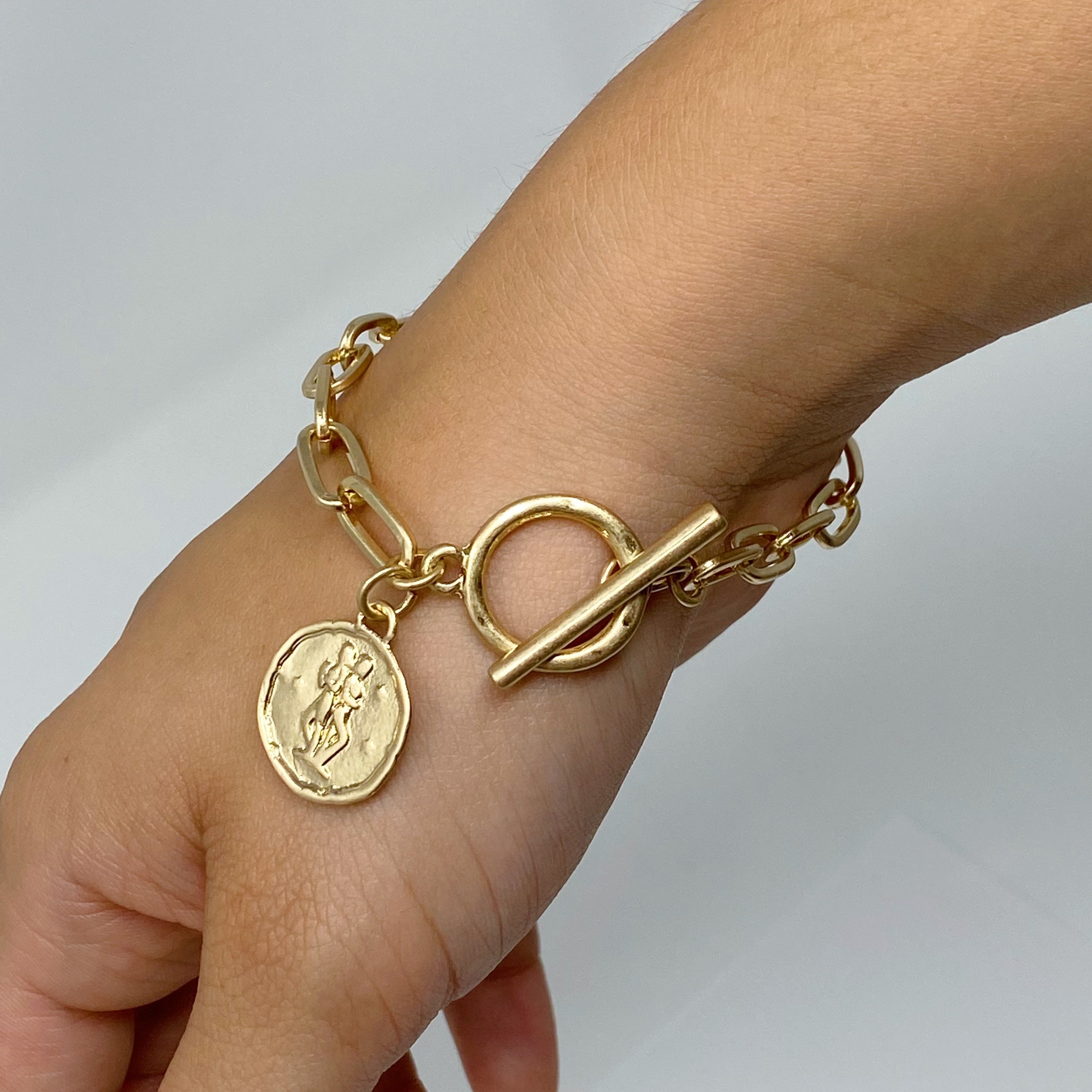 Zodiac Charm Chain Bracelet featuring a gold dipped brass link chain and a zodiac sign charm.