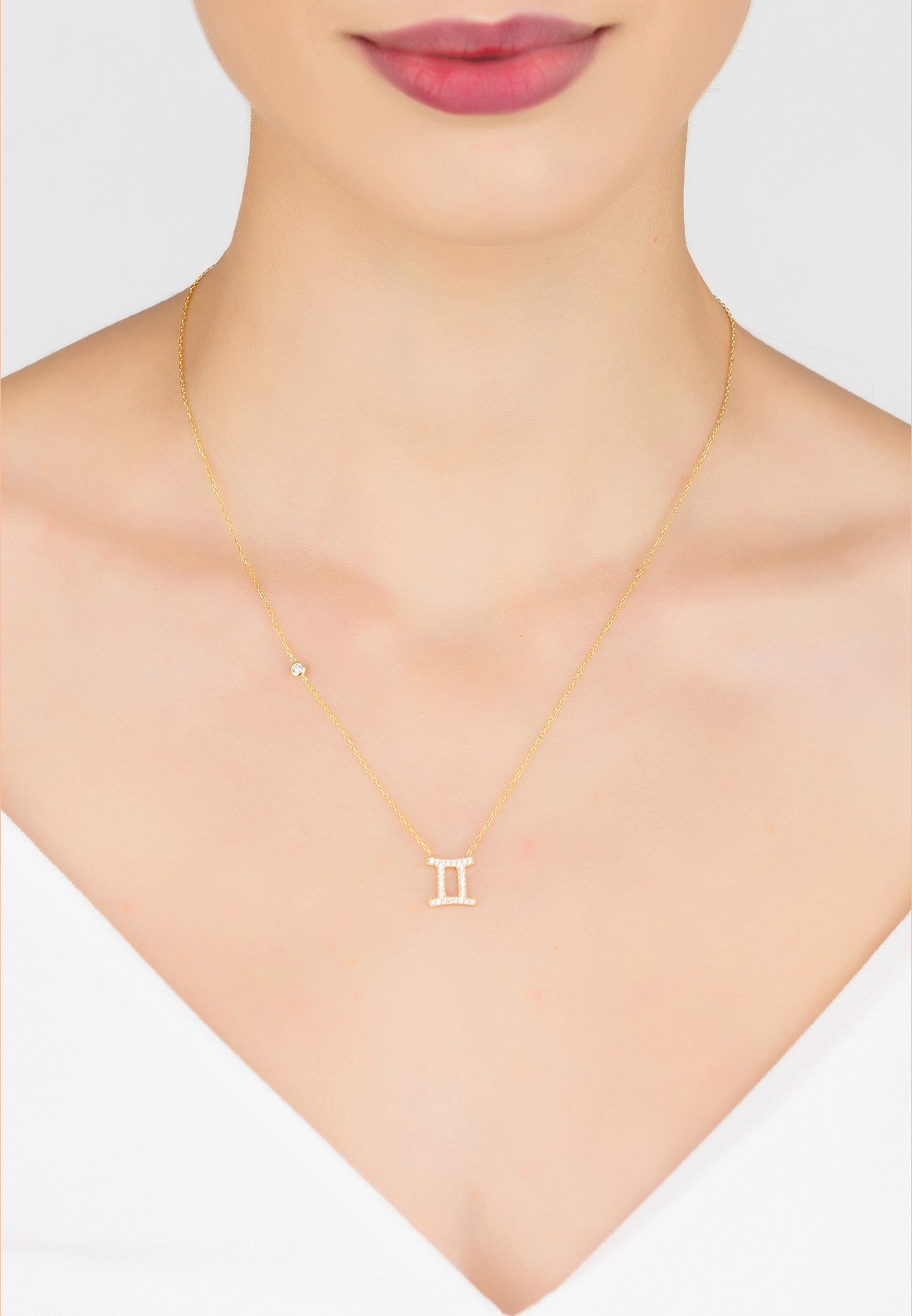 Gold Gemini Pendant Necklace made of 925 sterling silver, adorned with white zircons, featuring an adjustable chain.