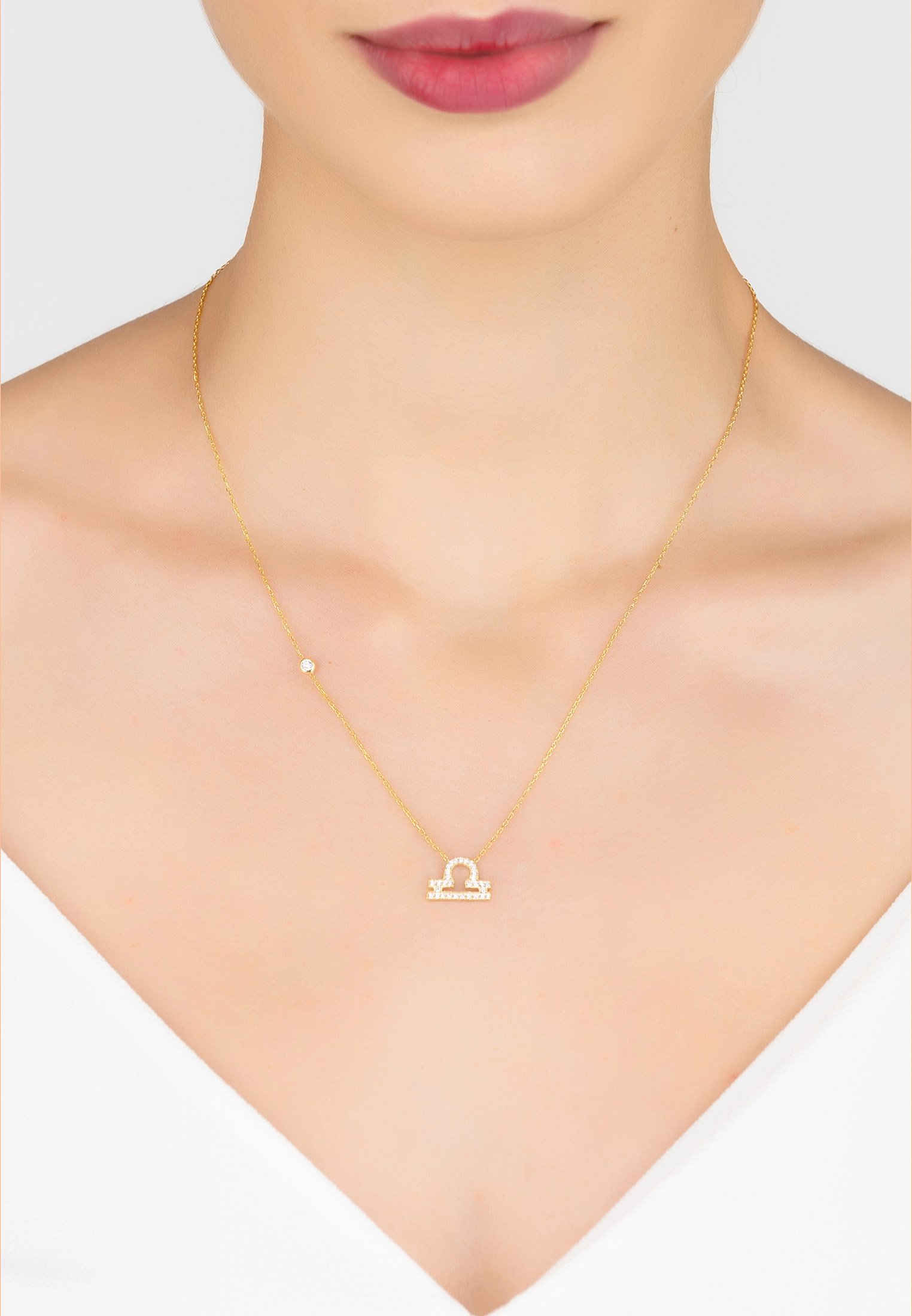 Gold Libra Pendant Necklace made of 925 sterling silver, adorned with white zircons, featuring an adjustable chain.