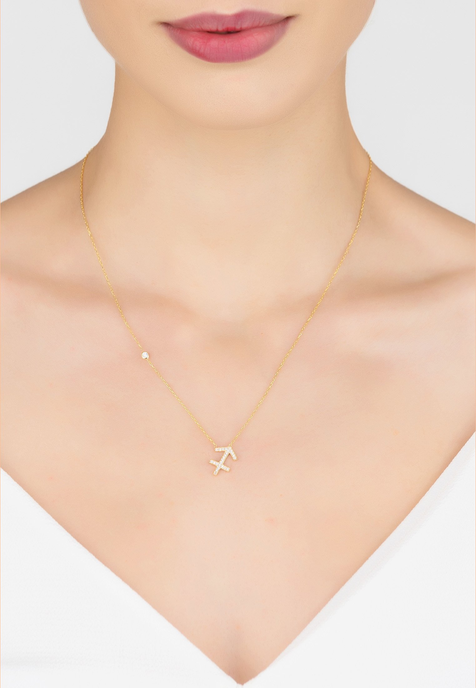 Gold Sagittarius Zodiac Star Sign Pendant Necklace with white zircons on a delicate chain.