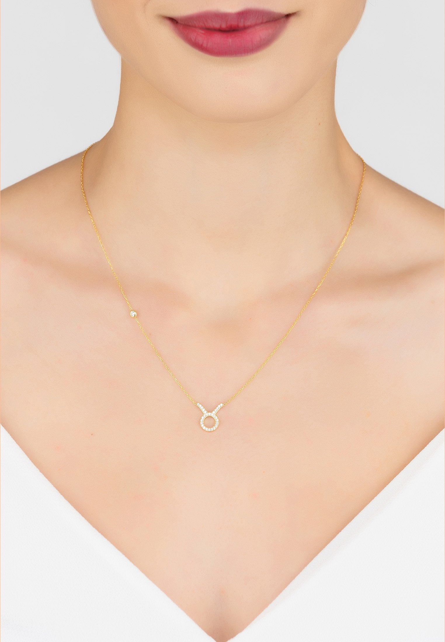 Gold Taurus zodiac pendant necklace made of 925 sterling silver, adorned with white zircons, featuring an adjustable chain.