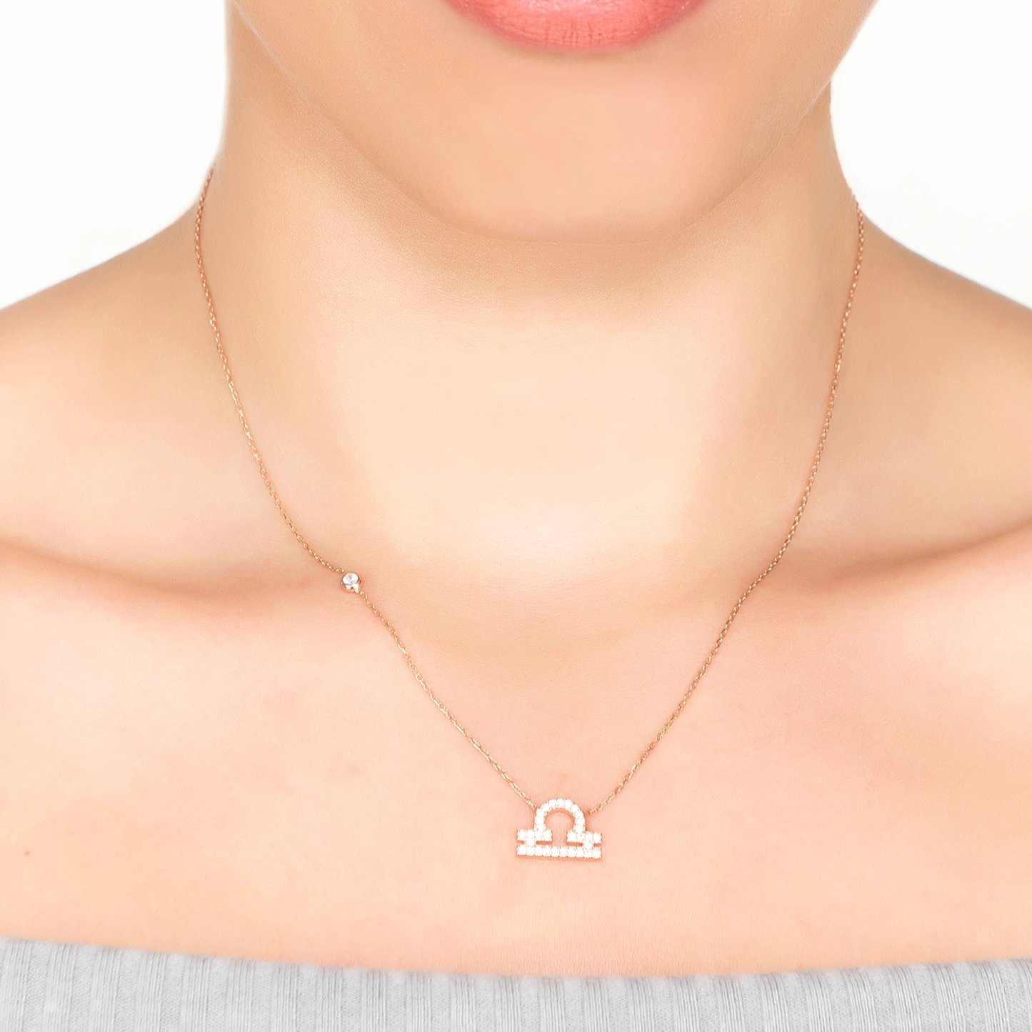 Silver Zodiac Star Sign Pendant Necklace featuring a Libra motif, adorned with white zircons, displayed elegantly.