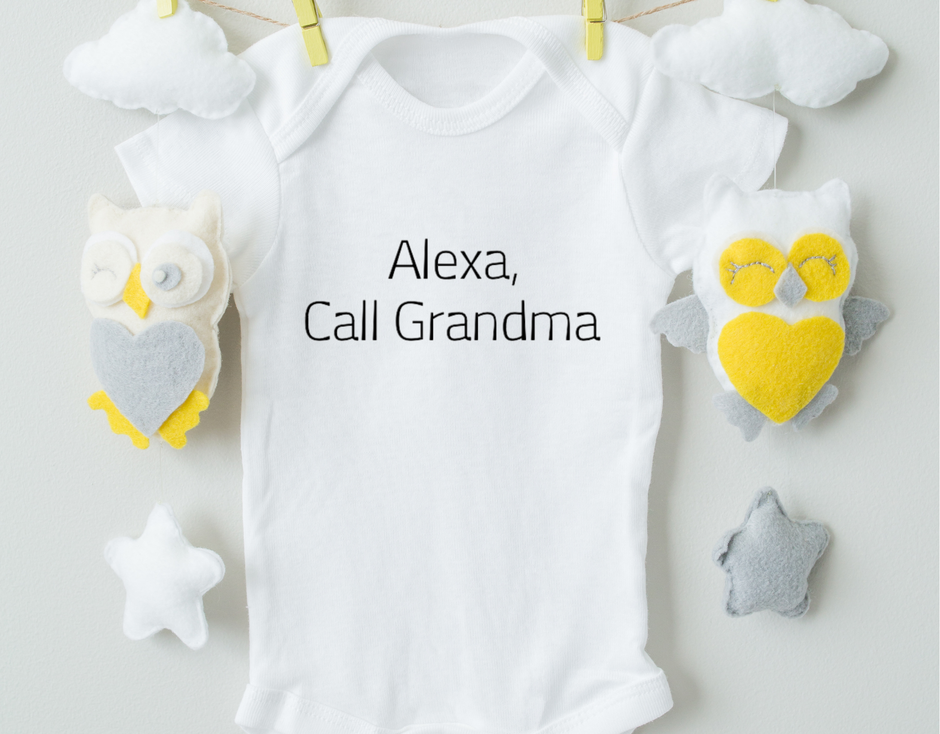 A cute cotton baby bodysuit featuring the phrase 'Alexa, Call Grandma' in vibrant heat transfer vinyl, perfect for infants.