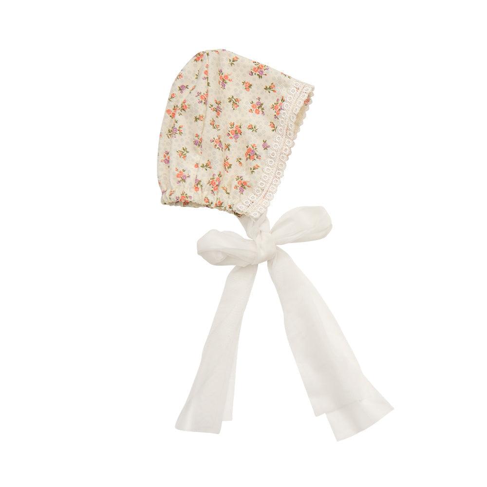 A vintage floral bonnet designed for babies, featuring delicate patterns and soft fabric, perfect for special occasions.