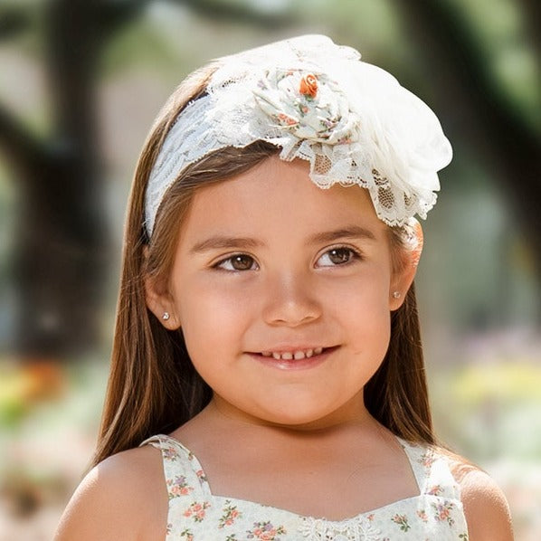 A floral and dainty Arabella Headband featuring intricate designs, perfect for stylish hair accessories.