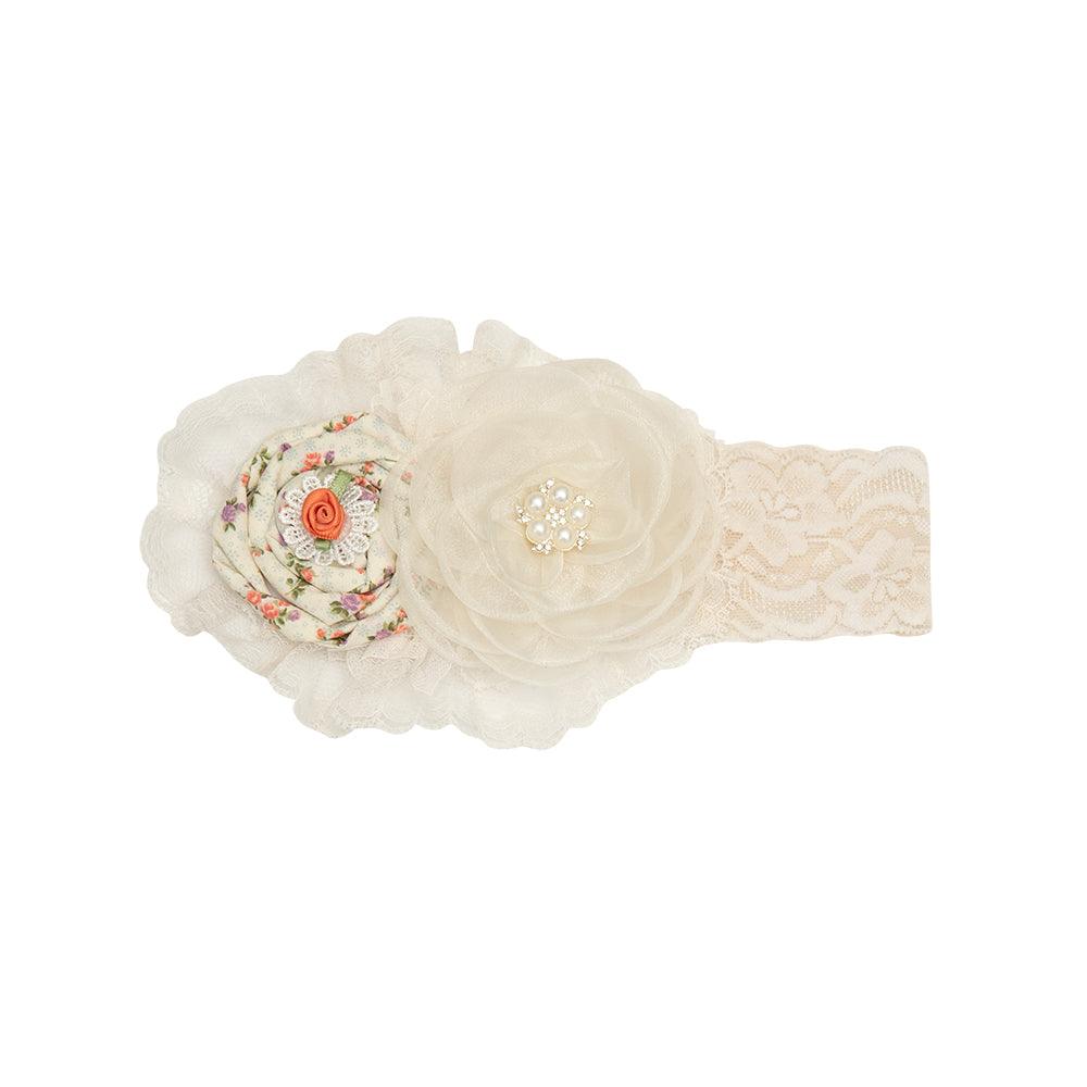 A floral and dainty Arabella Headband featuring intricate designs, perfect for stylish hair accessories.