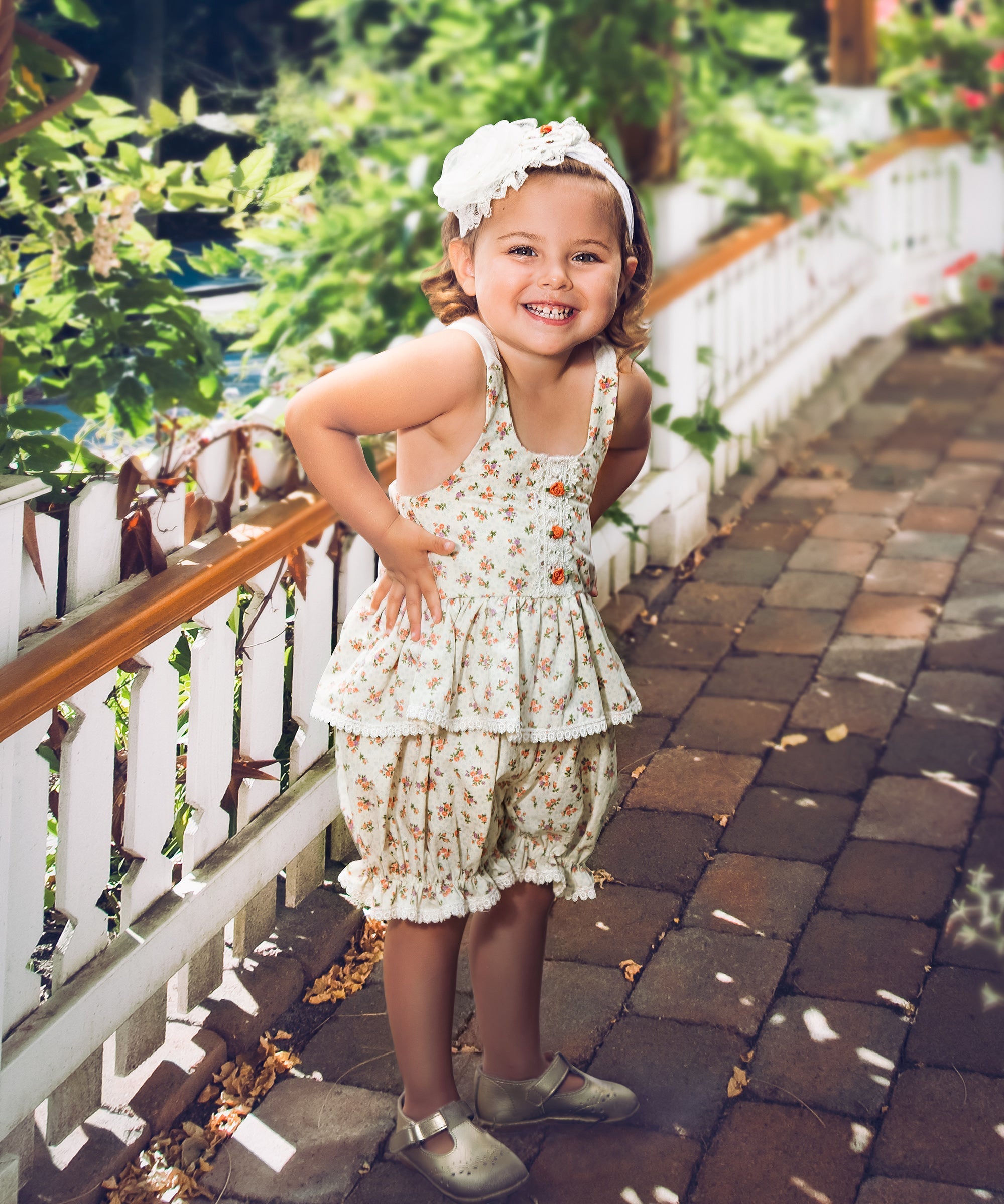 The Arabella Sunsuit featuring a floral pattern and delicate whispy ties, perfect for summer outings.