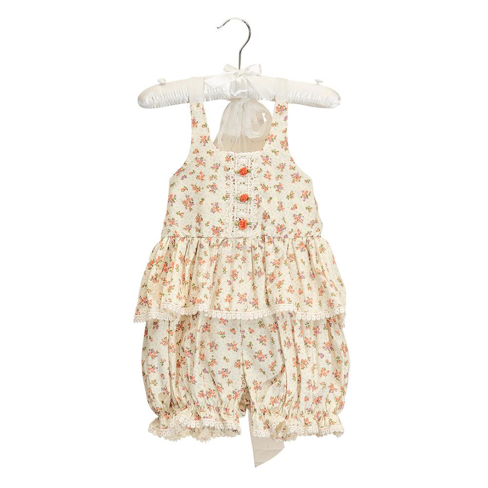 The Arabella Sunsuit featuring a floral pattern and delicate whispy ties, perfect for summer outings.