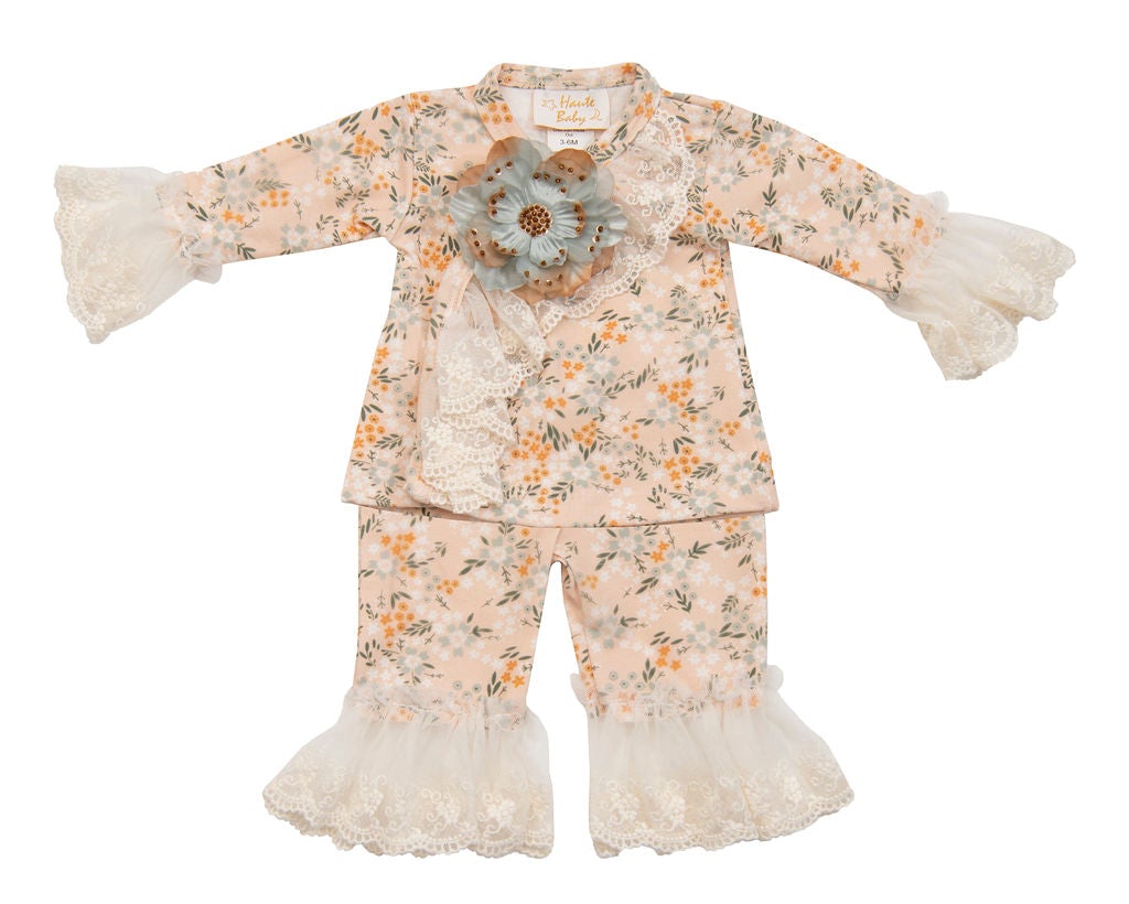 A stylish Avas Garden Crisscross Set featuring pastel orange colors and delicate lace details, perfect for casual outings.