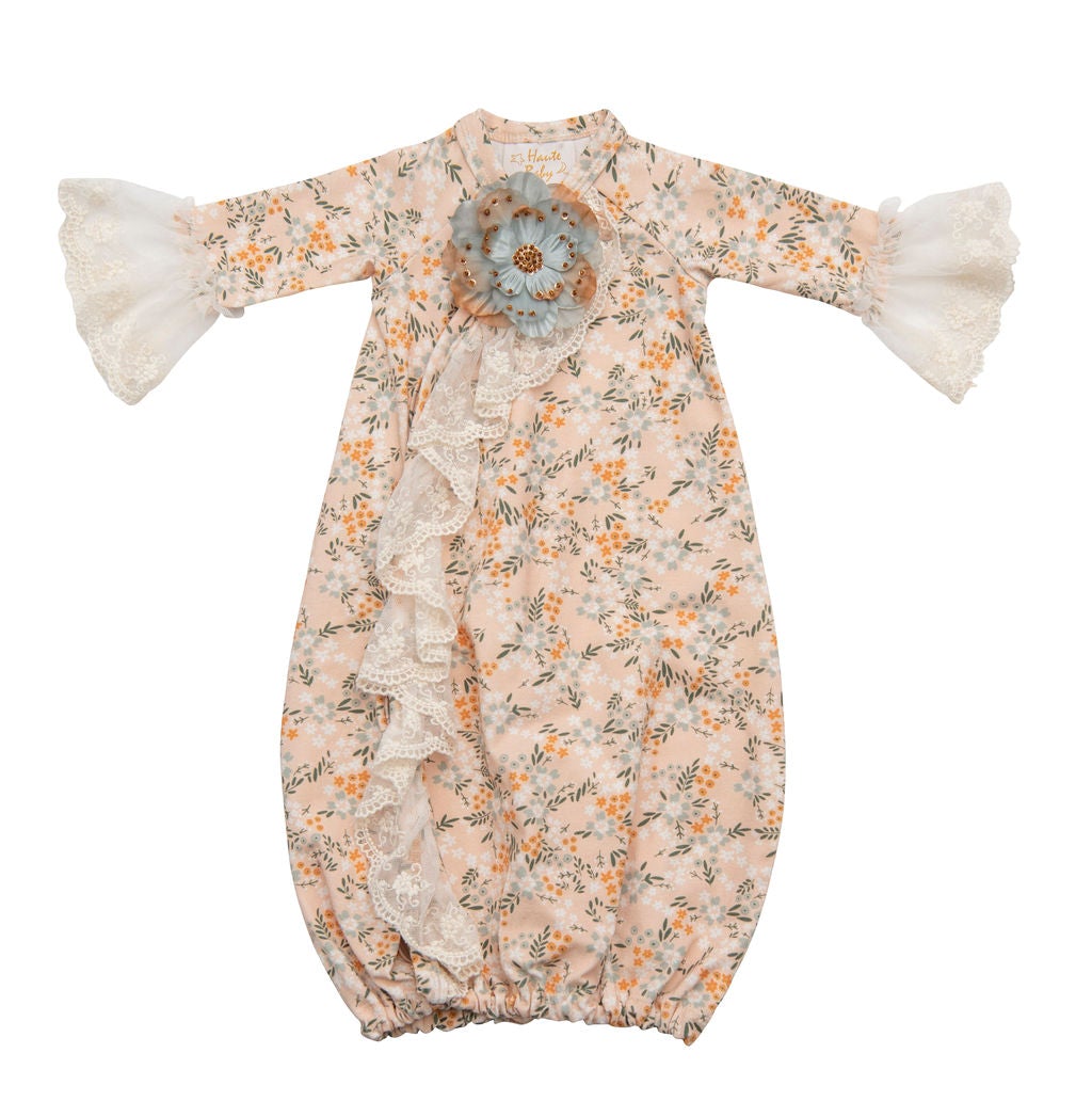 Avas Garden Gown featuring pastel orange fabric and intricate lace detailing, perfect for garden parties and special occasions.