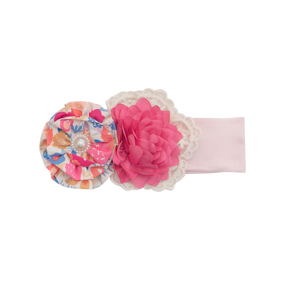 A stylish Bandera Blossom Headband featuring vibrant floral patterns, perfect for enhancing any outfit.