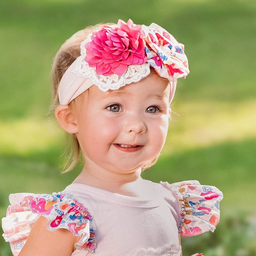 A stylish Bandera Blossom Headband featuring vibrant floral patterns, perfect for enhancing any outfit.