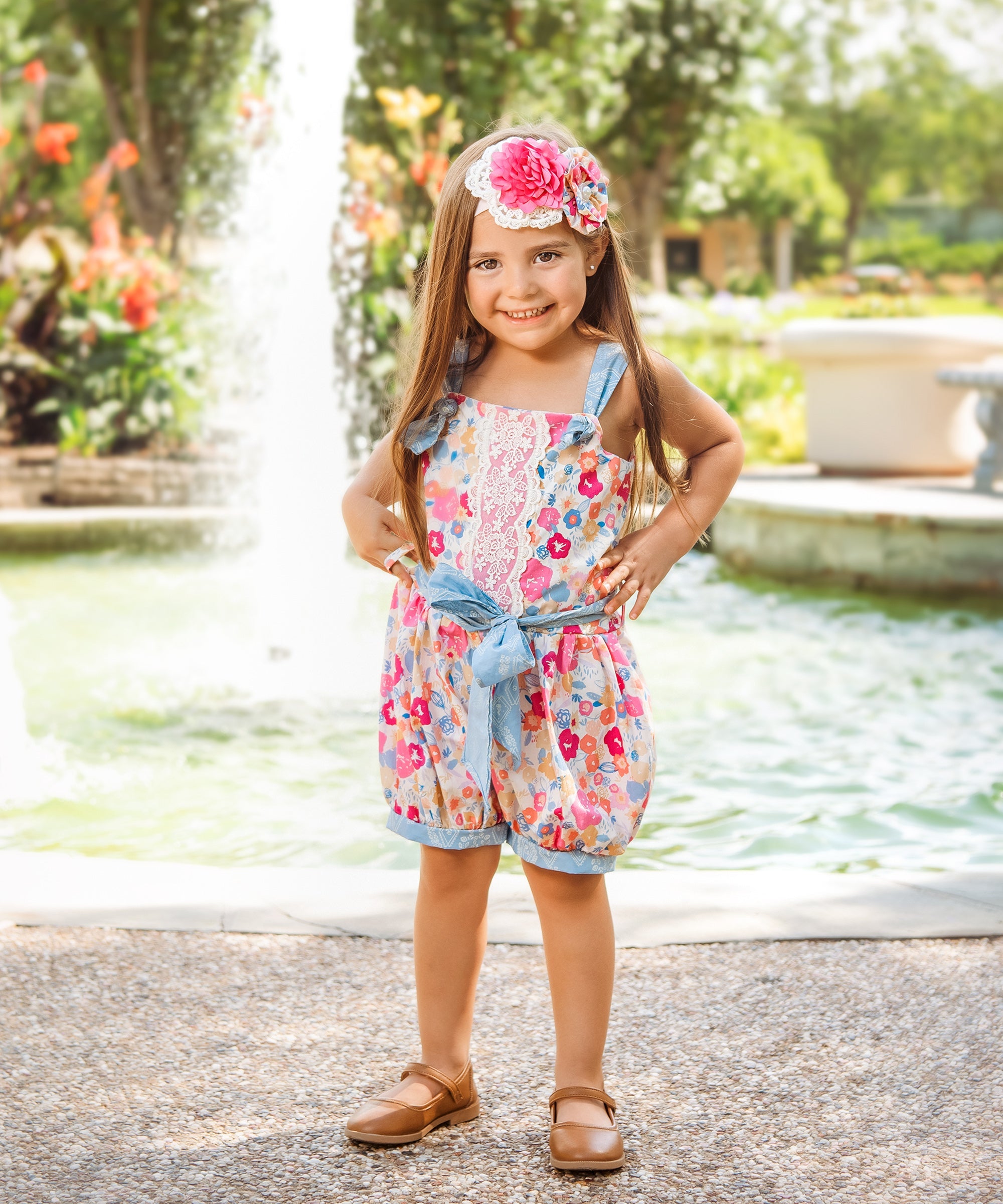 A stylish Bandera Blossom Romper featuring a vibrant floral pattern, perfect for summer outings.