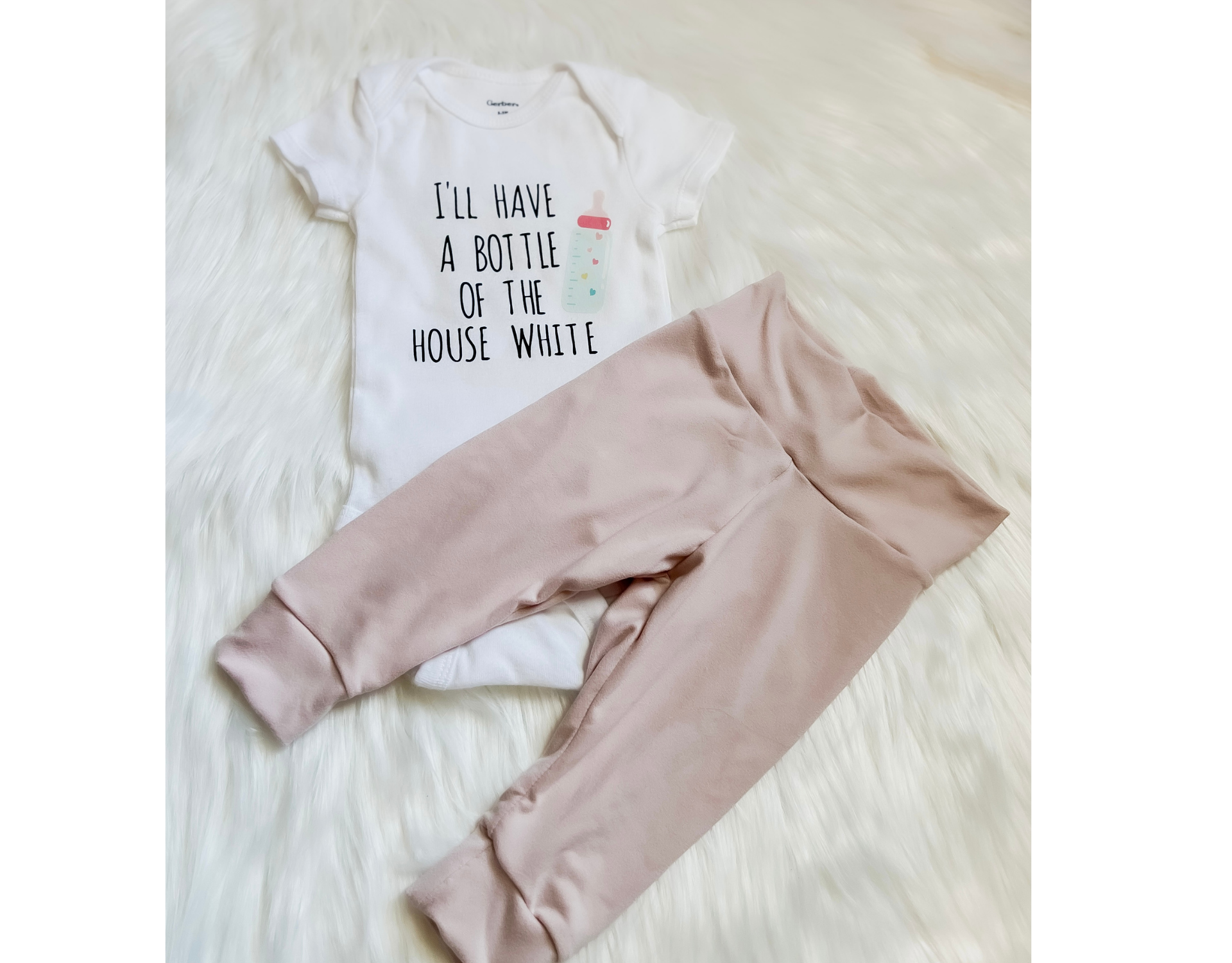 A soft and stylish Bottle of House White Baby Outfit featuring leggings and a bodysuit, perfect for babies.