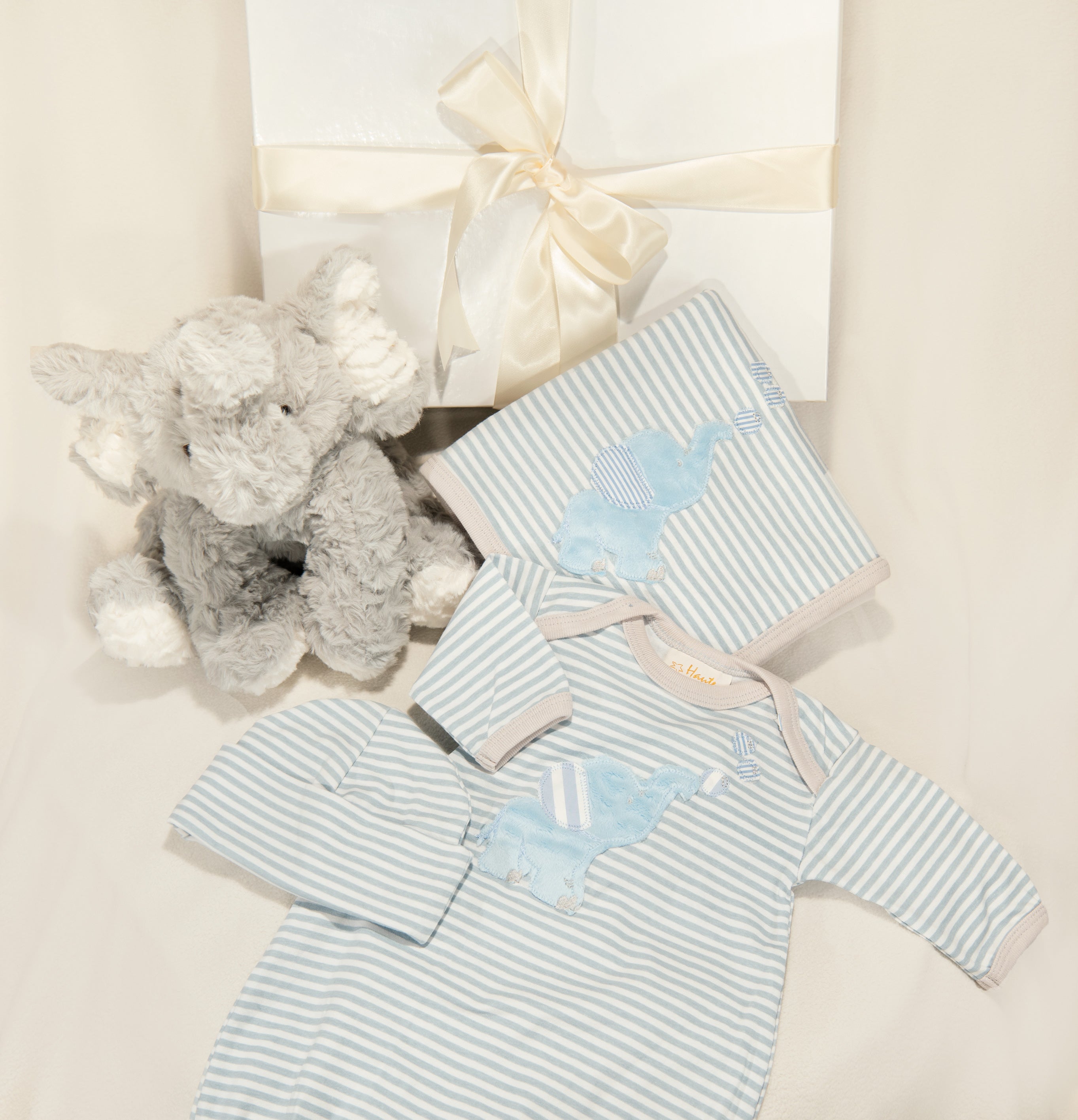 Bubbles Gown Set featuring a gown, blanket, cap, and plush elephant toy, designed for newborns.