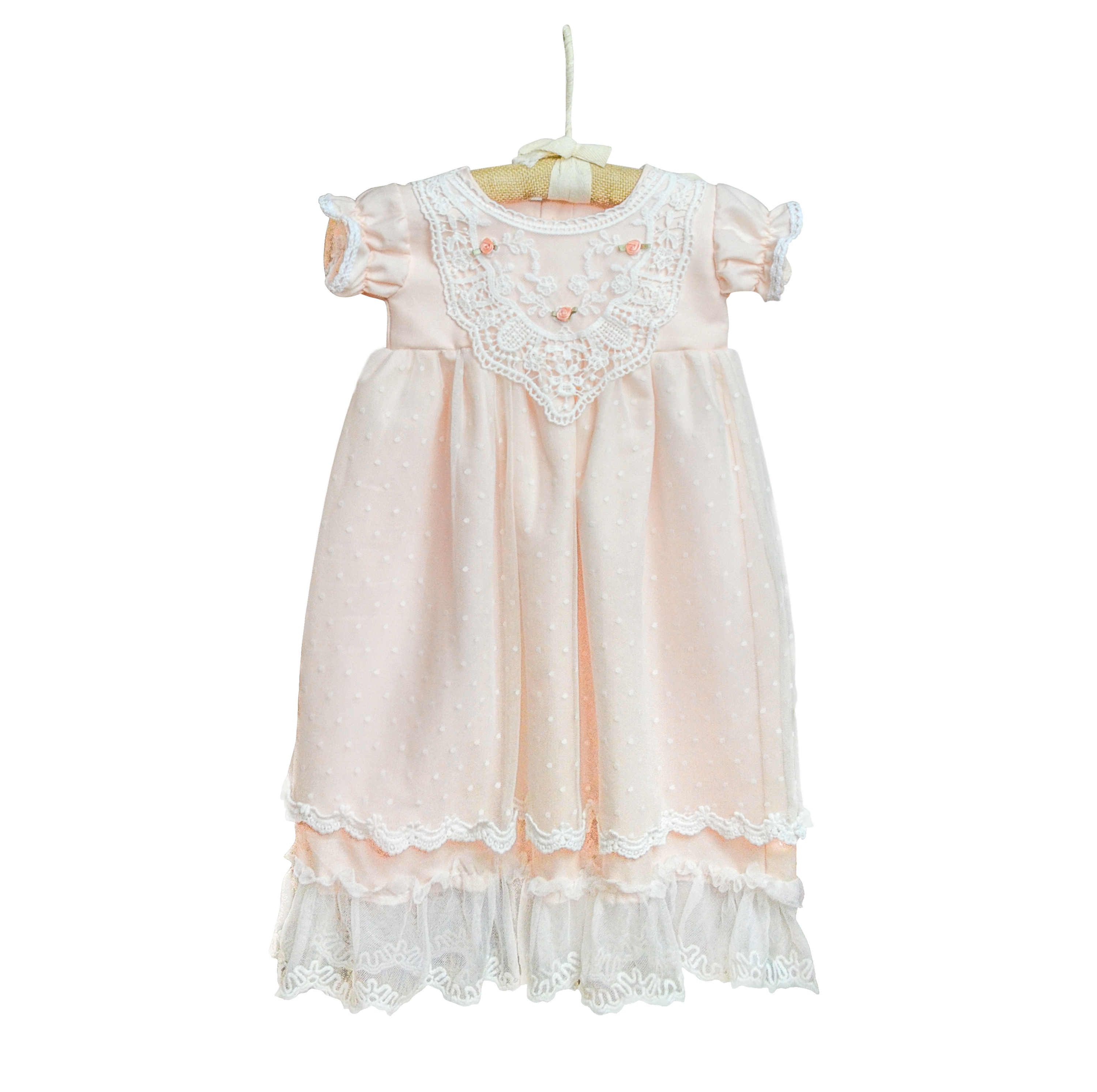 A beautiful pastel peach baby gown adorned with delicate rose embellishments, perfect for special occasions.