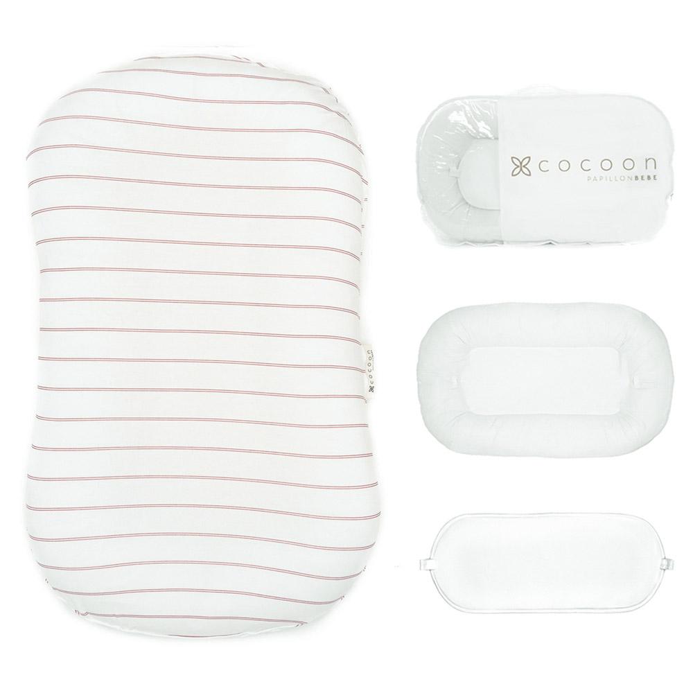 A cozy COCOON & COVER baby lounger in a soft color, featuring a removable liner and a custom-fit traveling case, designed for infants aged 0-36 months.