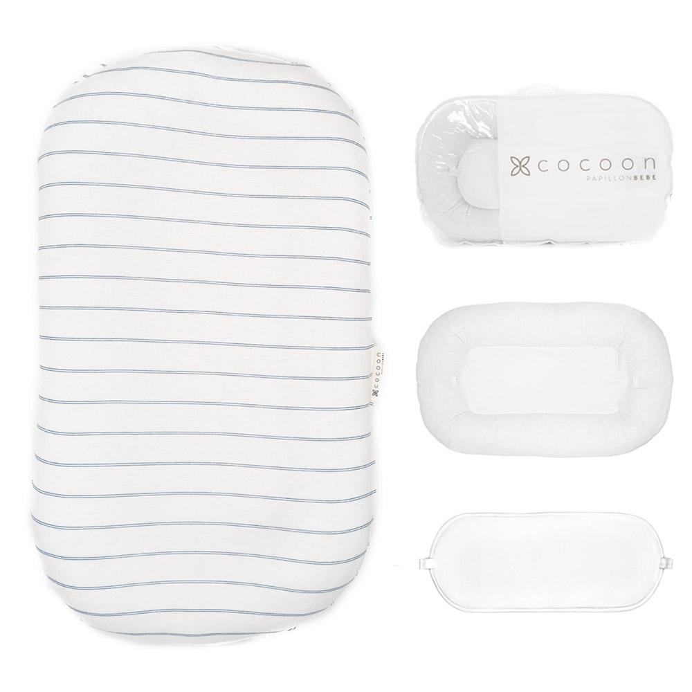 A cozy COCOON & COVER baby lounger in a soft color, featuring a removable liner and a custom-fit traveling case, designed for infants aged 0-36 months.