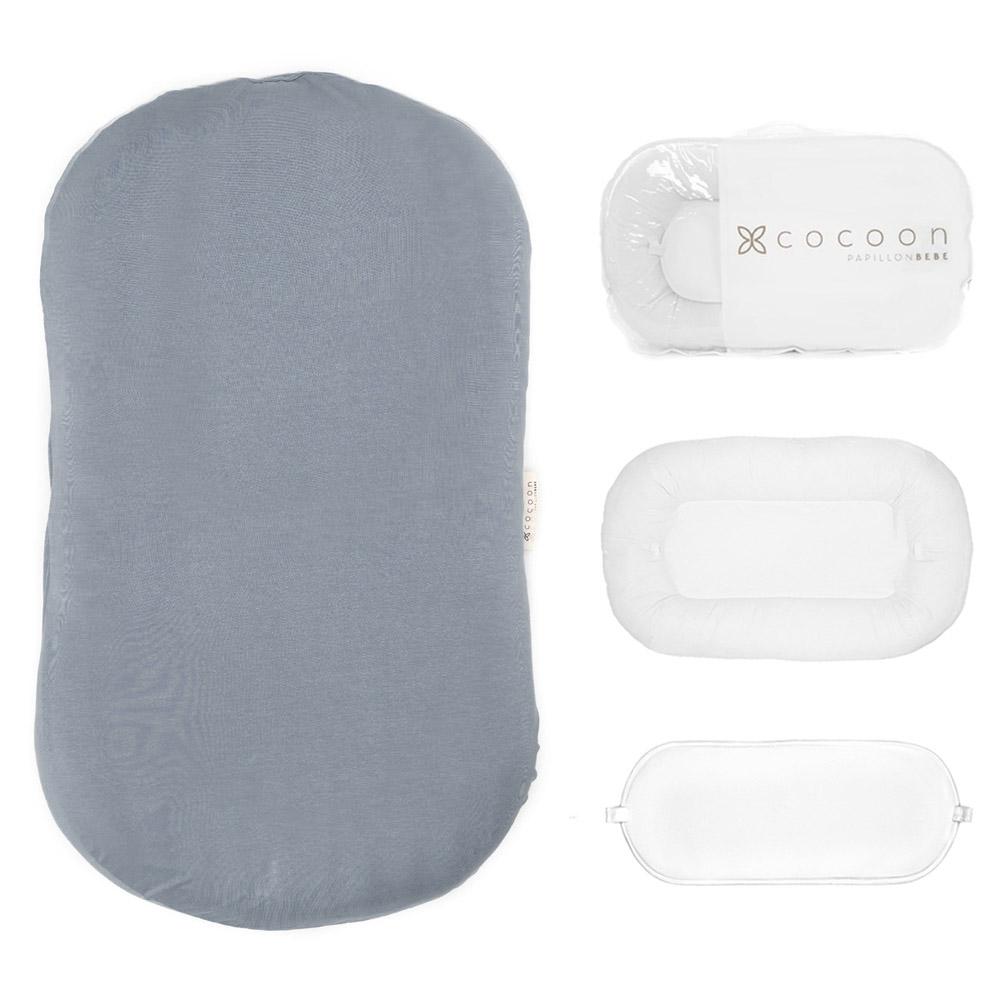 A cozy COCOON & COVER baby lounger in a soft color, featuring a removable liner and a custom-fit traveling case, designed for infants aged 0-36 months.