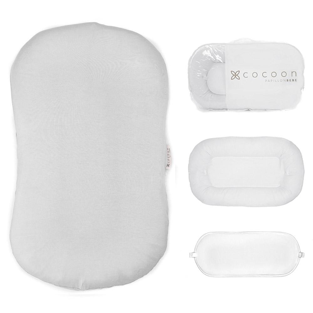 A cozy COCOON & COVER baby lounger in a soft color, featuring a removable liner and a custom-fit traveling case, designed for infants aged 0-36 months.