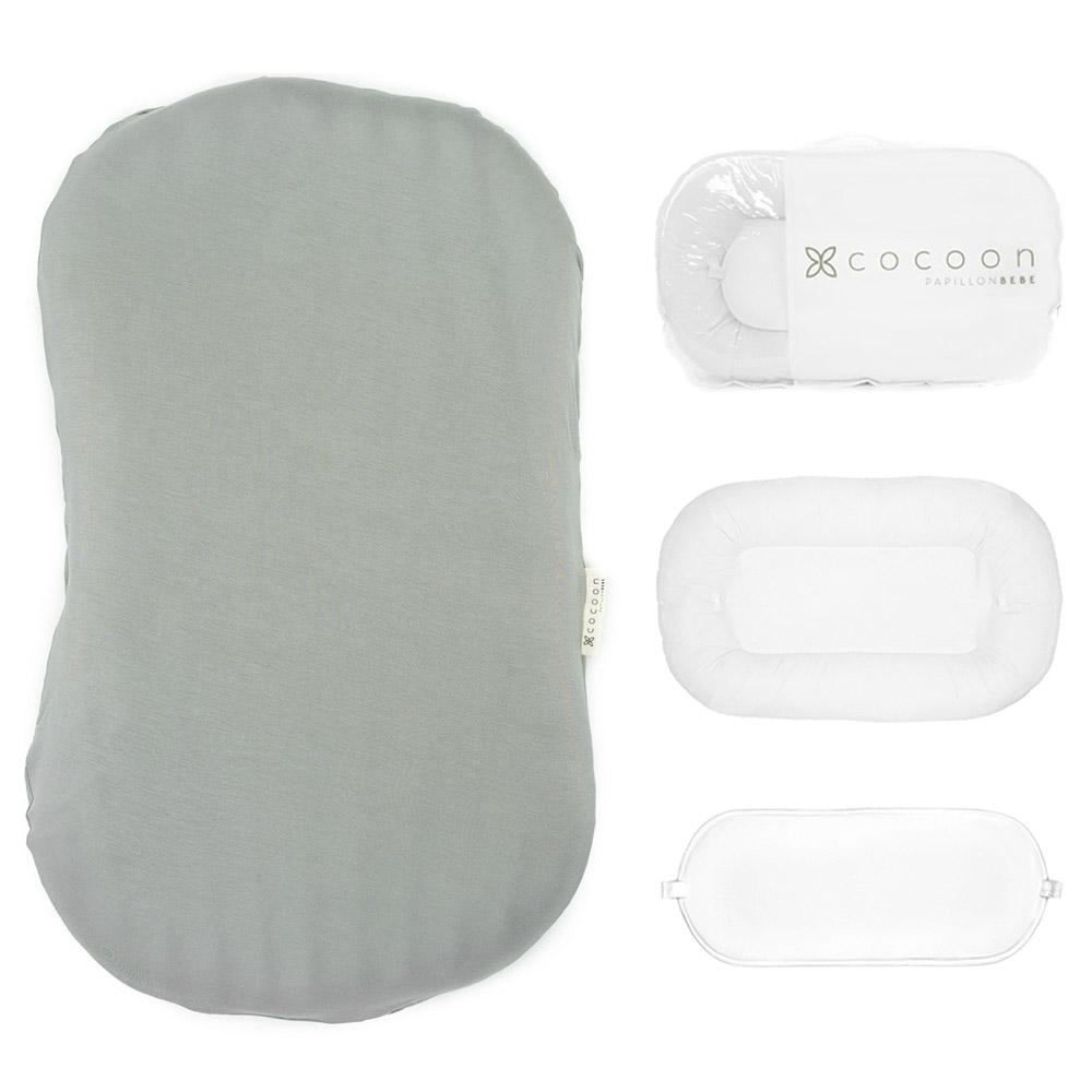 A cozy COCOON & COVER baby lounger in a soft color, featuring a removable liner and a custom-fit traveling case, designed for infants aged 0-36 months.