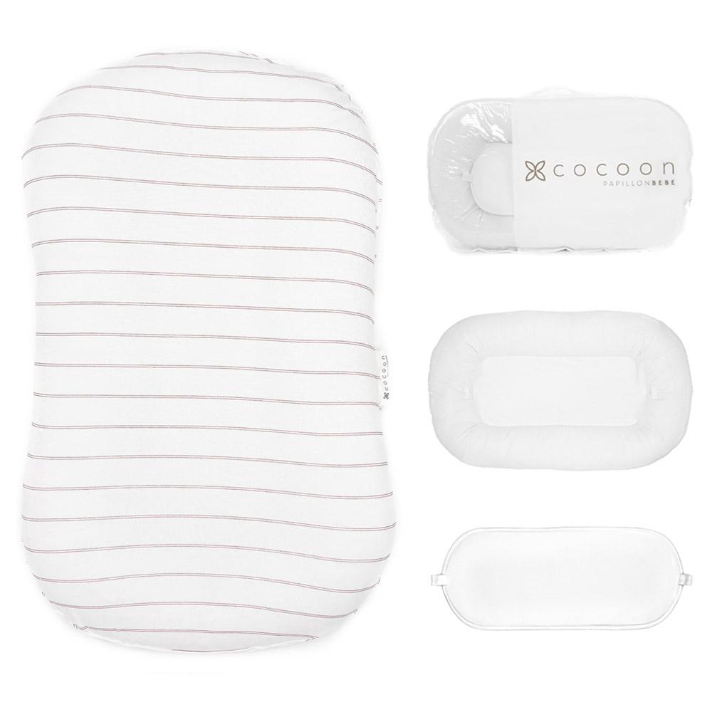 A cozy COCOON & COVER baby lounger in a soft color, featuring a removable liner and a custom-fit traveling case, designed for infants aged 0-36 months.