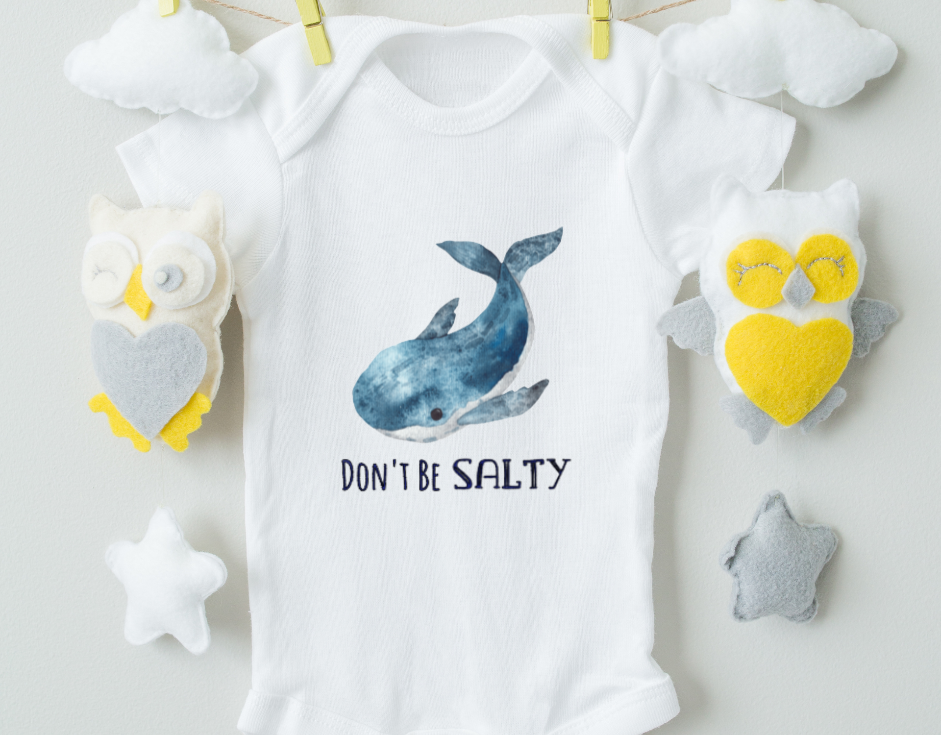 Don't Be Salty Whale Baby Bodysuit featuring a playful whale design on a soft cotton fabric.