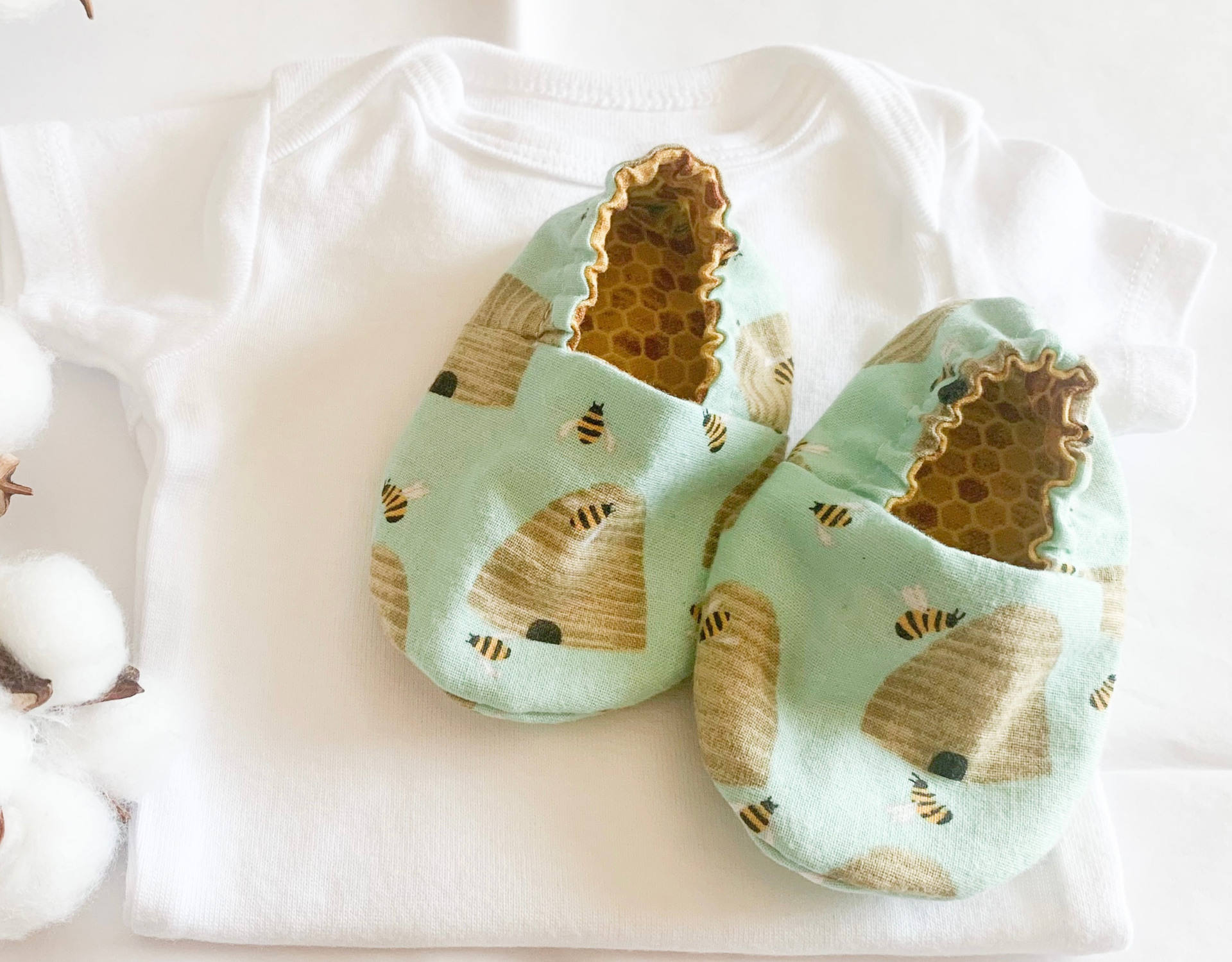 Honey Bee Elastic Baby Shoe featuring beehives and bees on a mint background, with a honeycomb pattern lining.