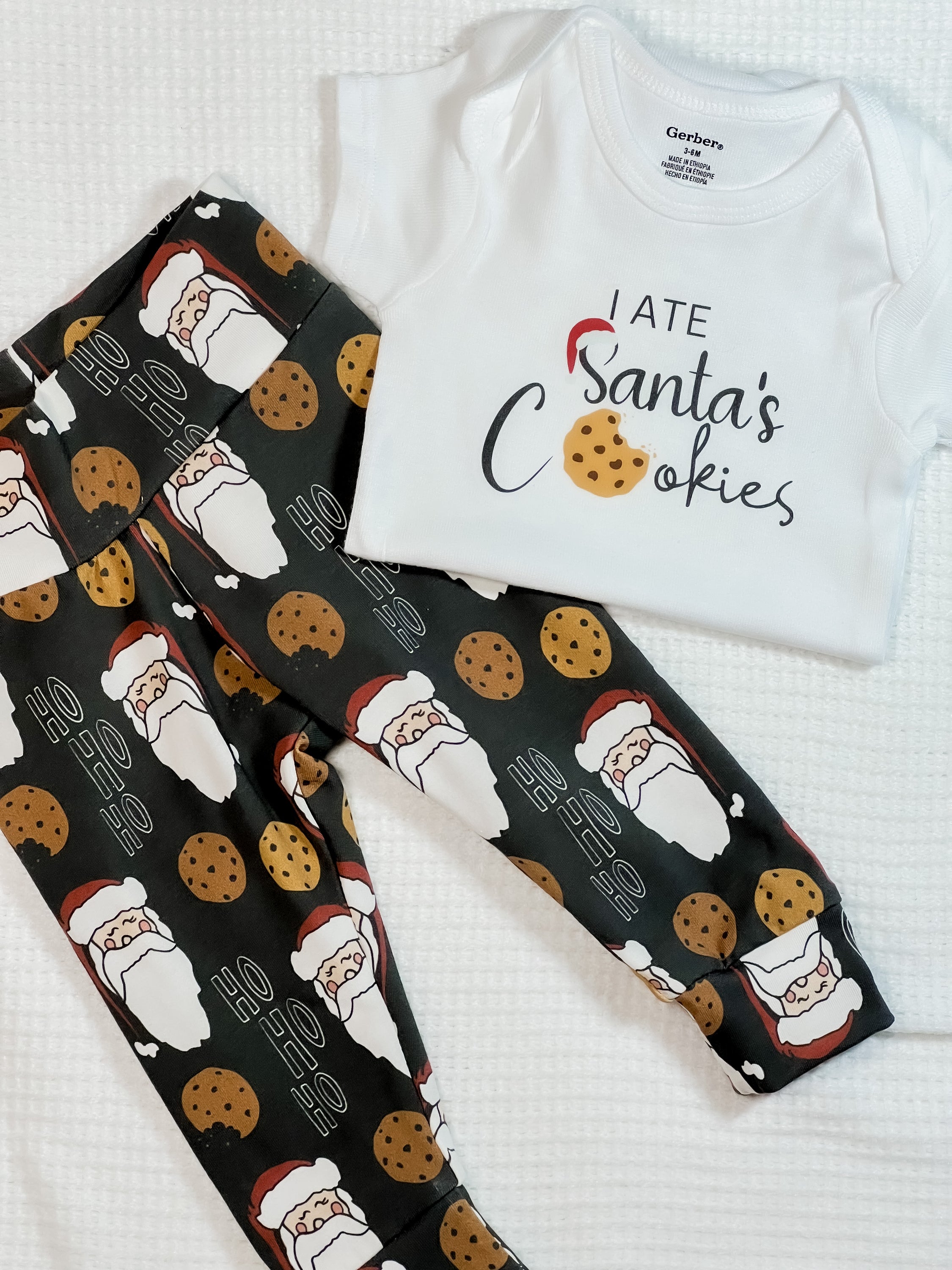 Adorable I ate Santa's Cookies baby outfit featuring a cute design with leggings and a bodysuit, perfect for holiday celebrations.