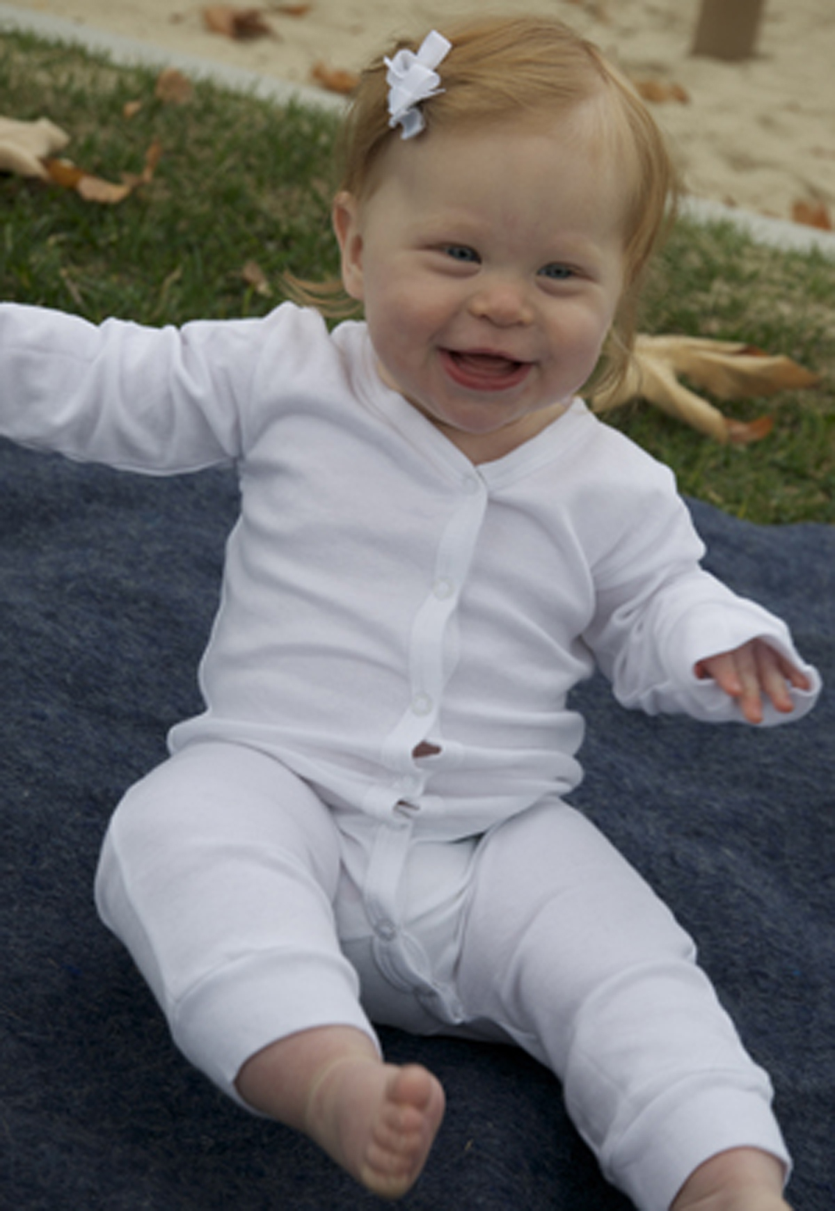 A pair of white interlock union suit long johns for children, made from 100% cotton, featuring a soft and cozy design.