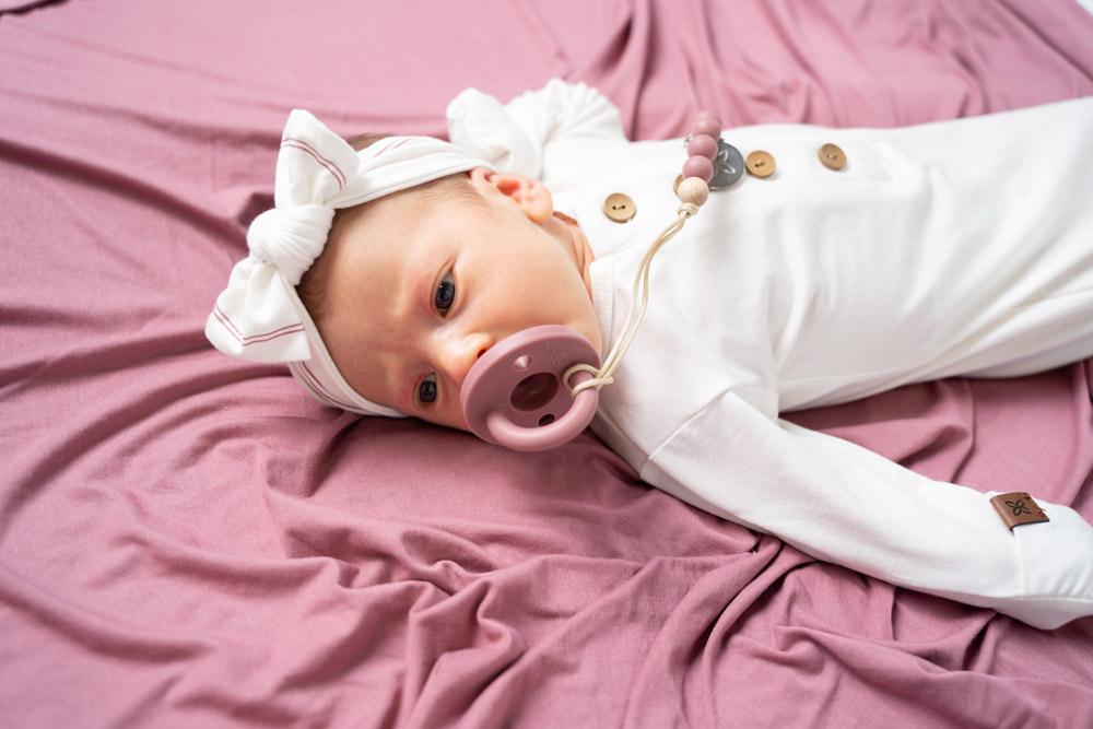 A soft and stretchy knotted bow accessory for babies, showcasing its stylish design and comfortable fit.