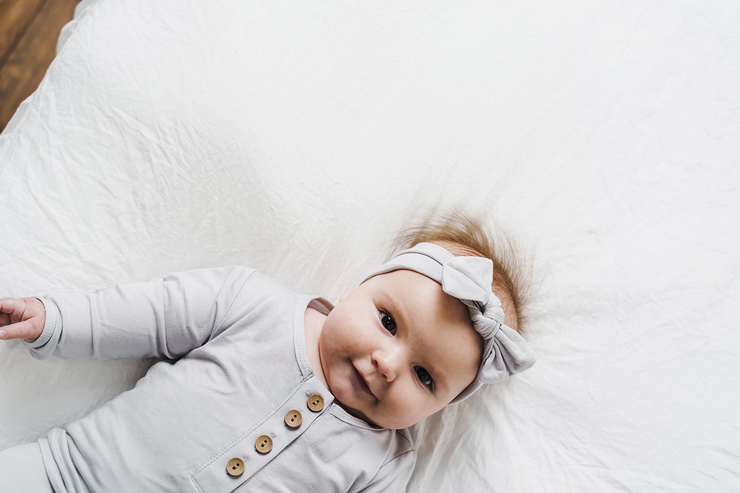 A soft and stretchy knotted bow accessory for babies, showcasing its stylish design and comfortable fit.