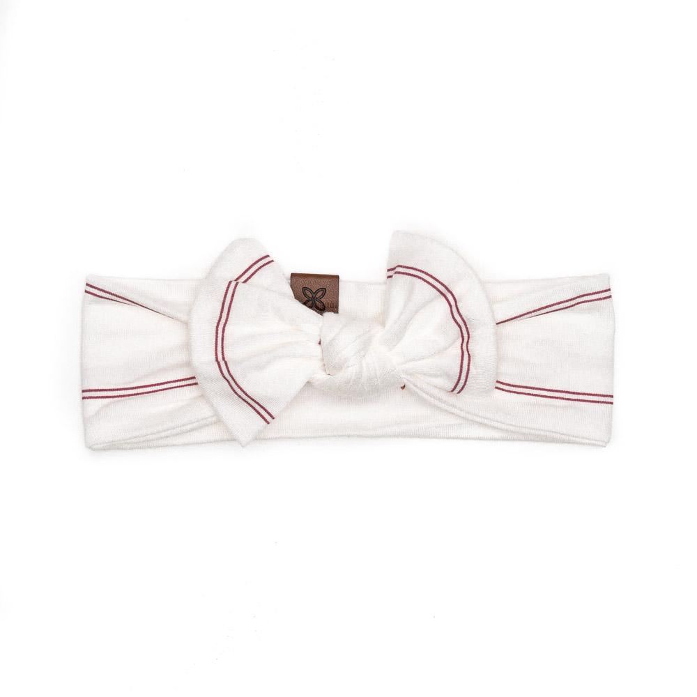 A soft and stretchy knotted bow accessory for babies, showcasing its stylish design and comfortable fit.