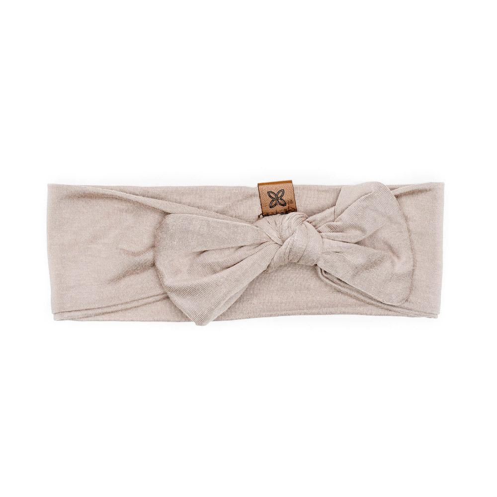 A soft and stretchy knotted bow accessory for babies, showcasing its stylish design and comfortable fit.