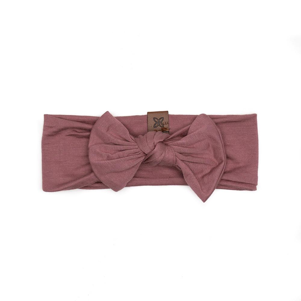 A soft and stretchy knotted bow accessory for babies, showcasing its stylish design and comfortable fit.